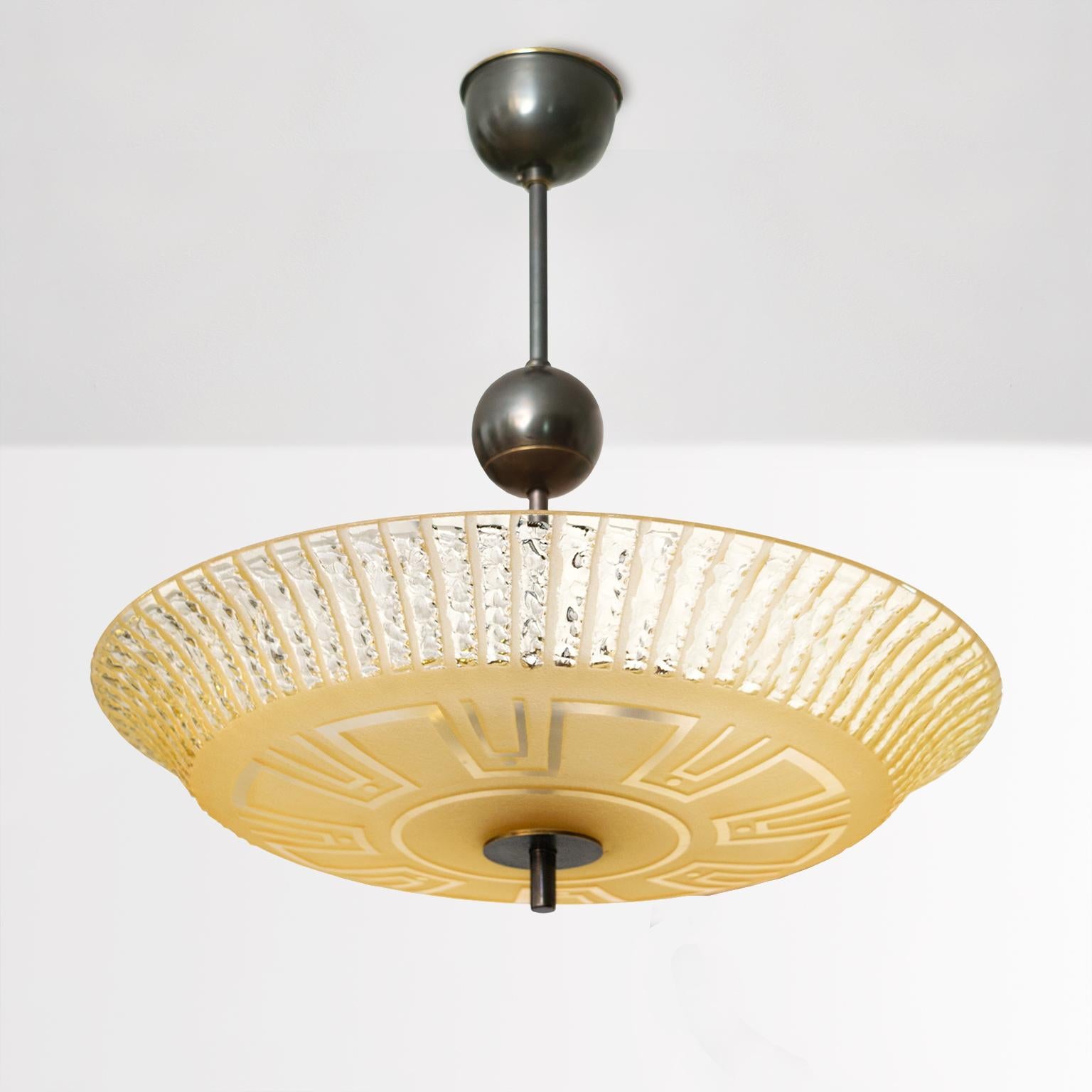 Scandinavian Modern, Swedish Art Deco hand and acid etched pale amber glass shade with Meander pattern, made by Orrefors. The brass canopy, stem and finial are all custom patinated, newly rewired with 3 standard base sockets for use in the USA .