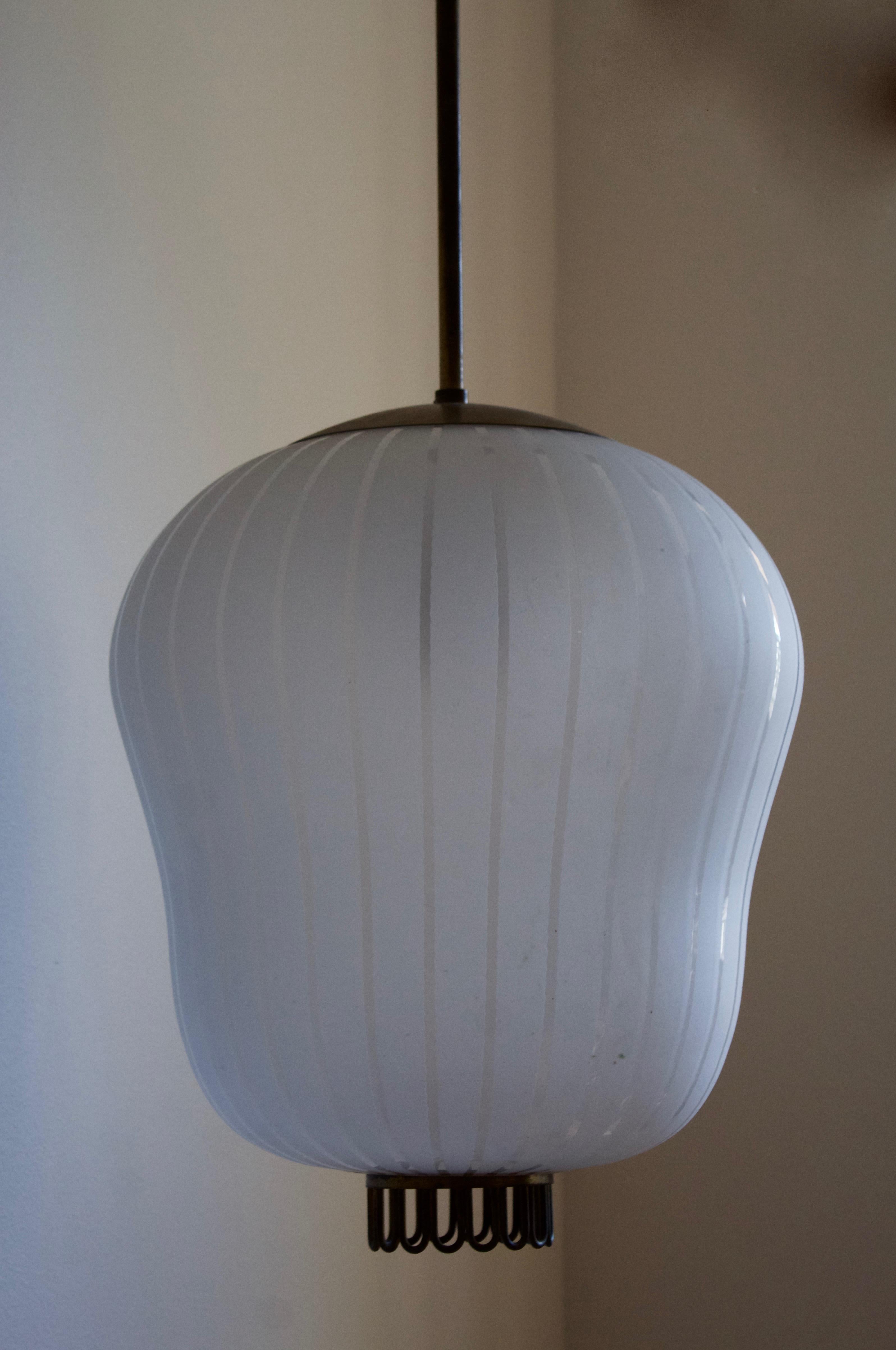 A sizable pendant light. Designed and produced by Orrefors. Features frosted glass, brass. 

Height stated includes full drop.