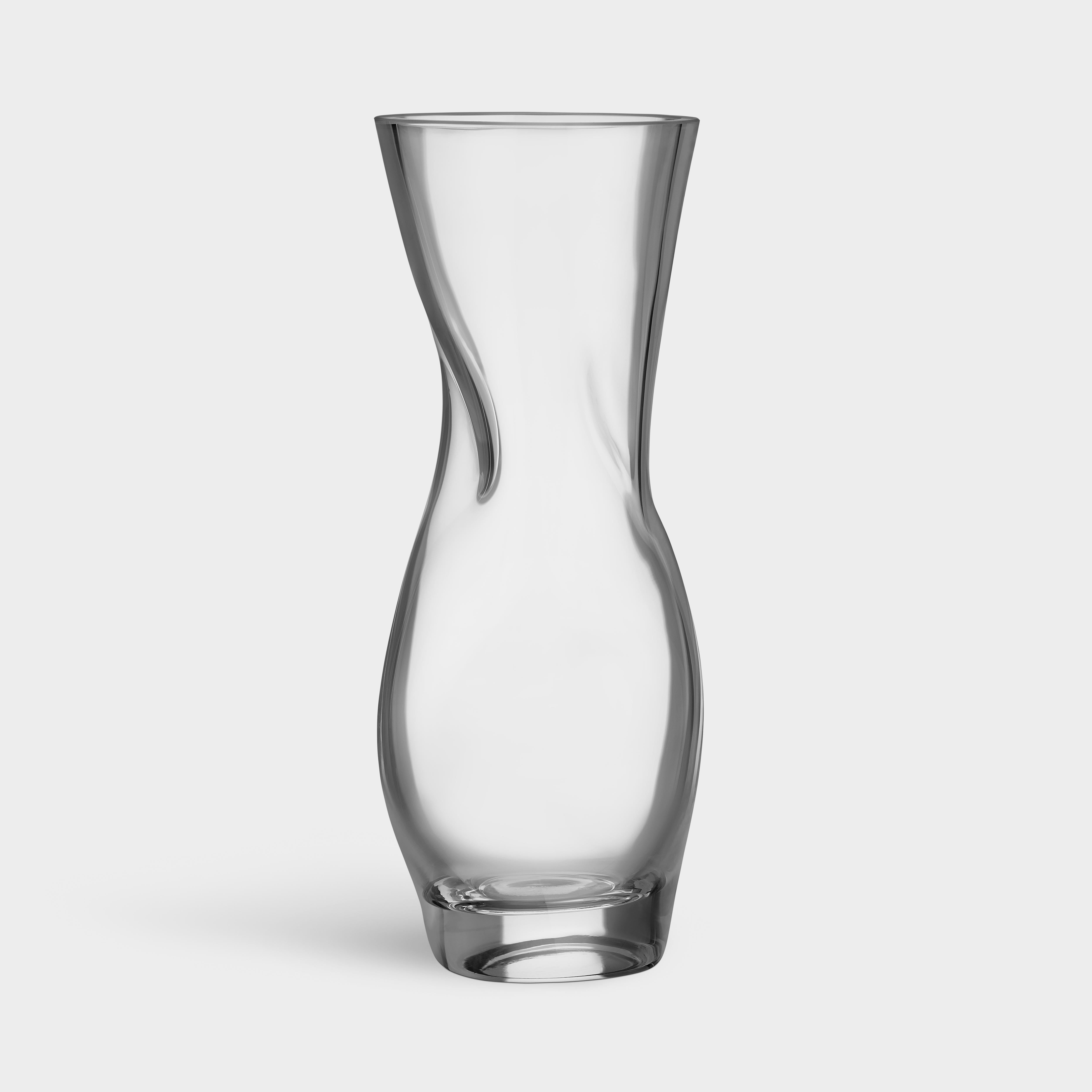 The billowy shape of Squeeze from Orrefors looks different from different angles, depending on its placement. After the vase is blown, and while still hot, it is “squeezed” together by hand in two places. These “squeezes” form a cross inside the