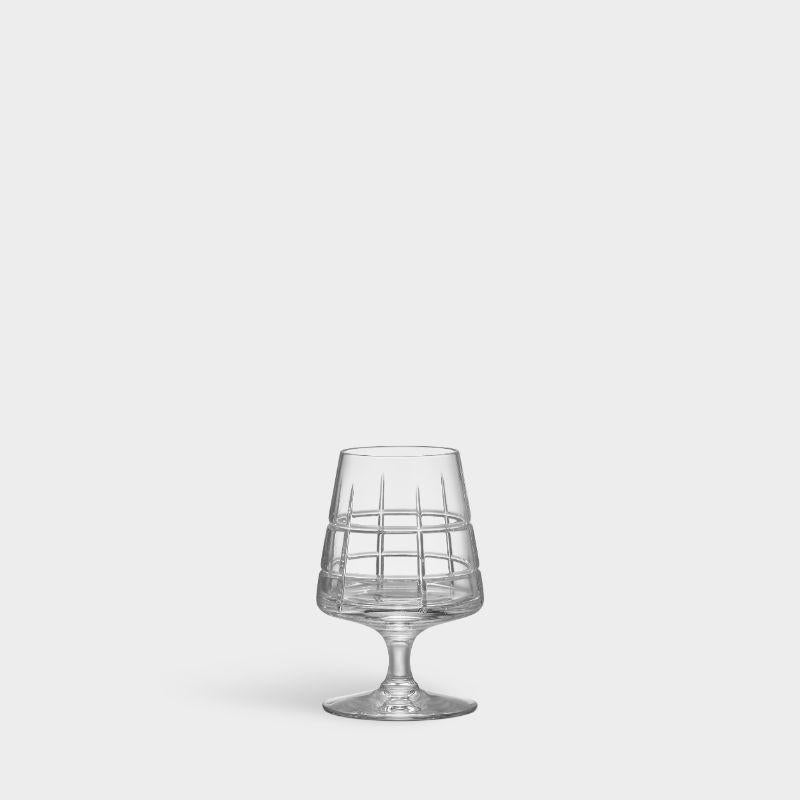 Street Cognac from Orrefors, which holds 5 oz, is ideal for cognac, as well as other barrel-aged spirits. The stemware glass has a checked motif of straight lines inspired by the criss-cross streets and avenues of Manhattan, New York. Designed by