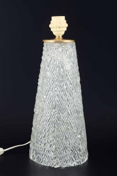 Orrefors, Sweden. Conical table lamp in clear crystal glass and brass.