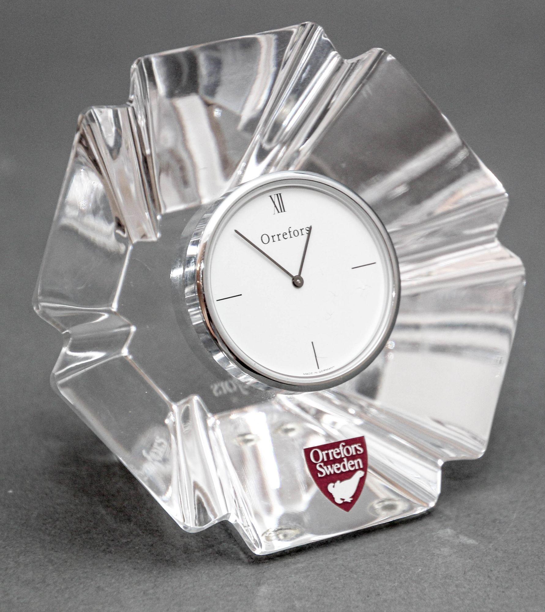 Orrefors Sweden Crystal Orion Desk Clock by Lars Hellsten circa 1970s.
The Swedish crystal desk clock designed by sculptor Lars Hellsten for Orrefors, showcases a flared form with a scalloped edge and is signed with a marked with needle-etched