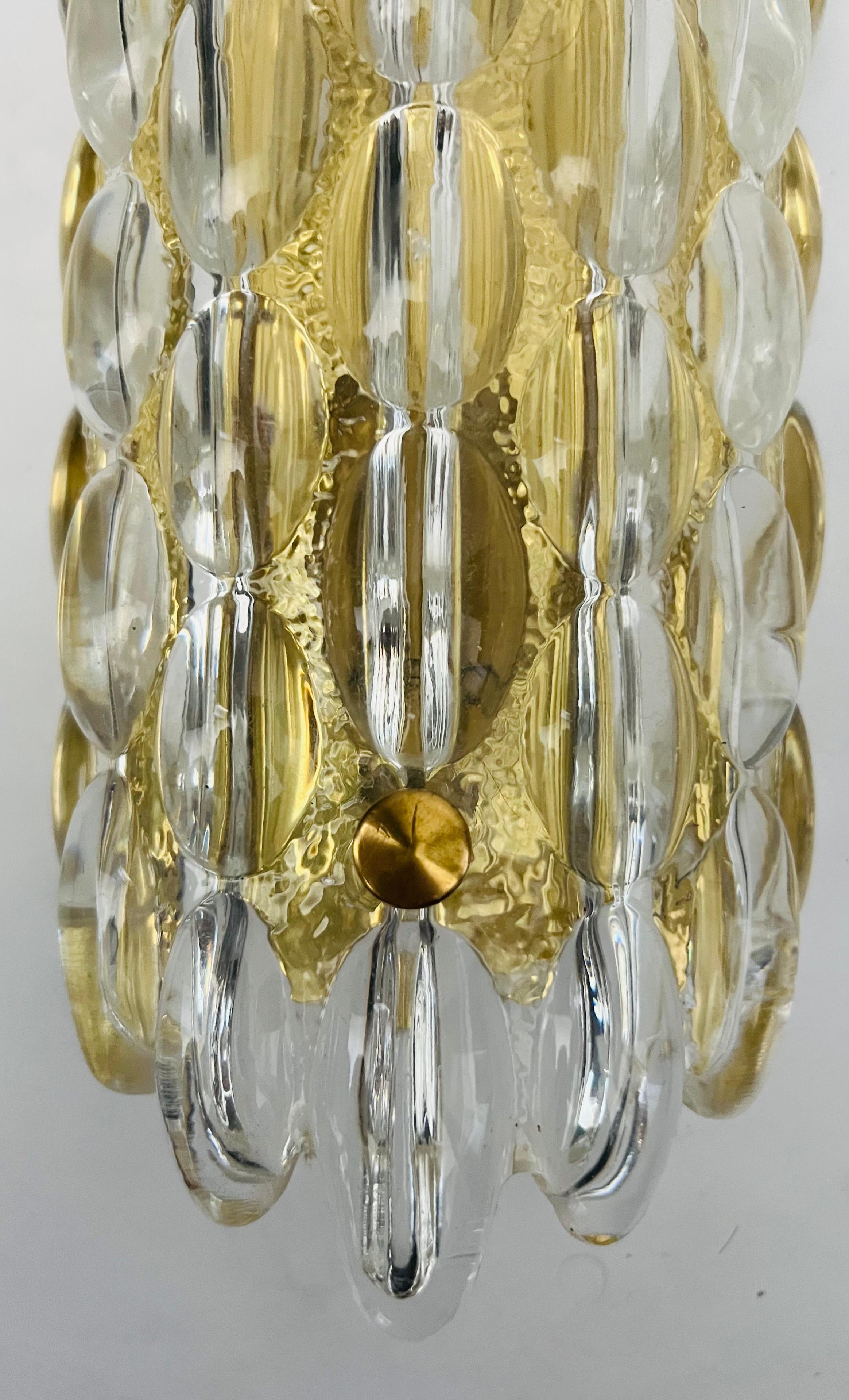 A beautiful thick bubble crystal wall lamp by the famed Swedish maker, Orrefors. Newly rewired with candelabra sockets. Polished brass fixture and fittings. 3 Available.