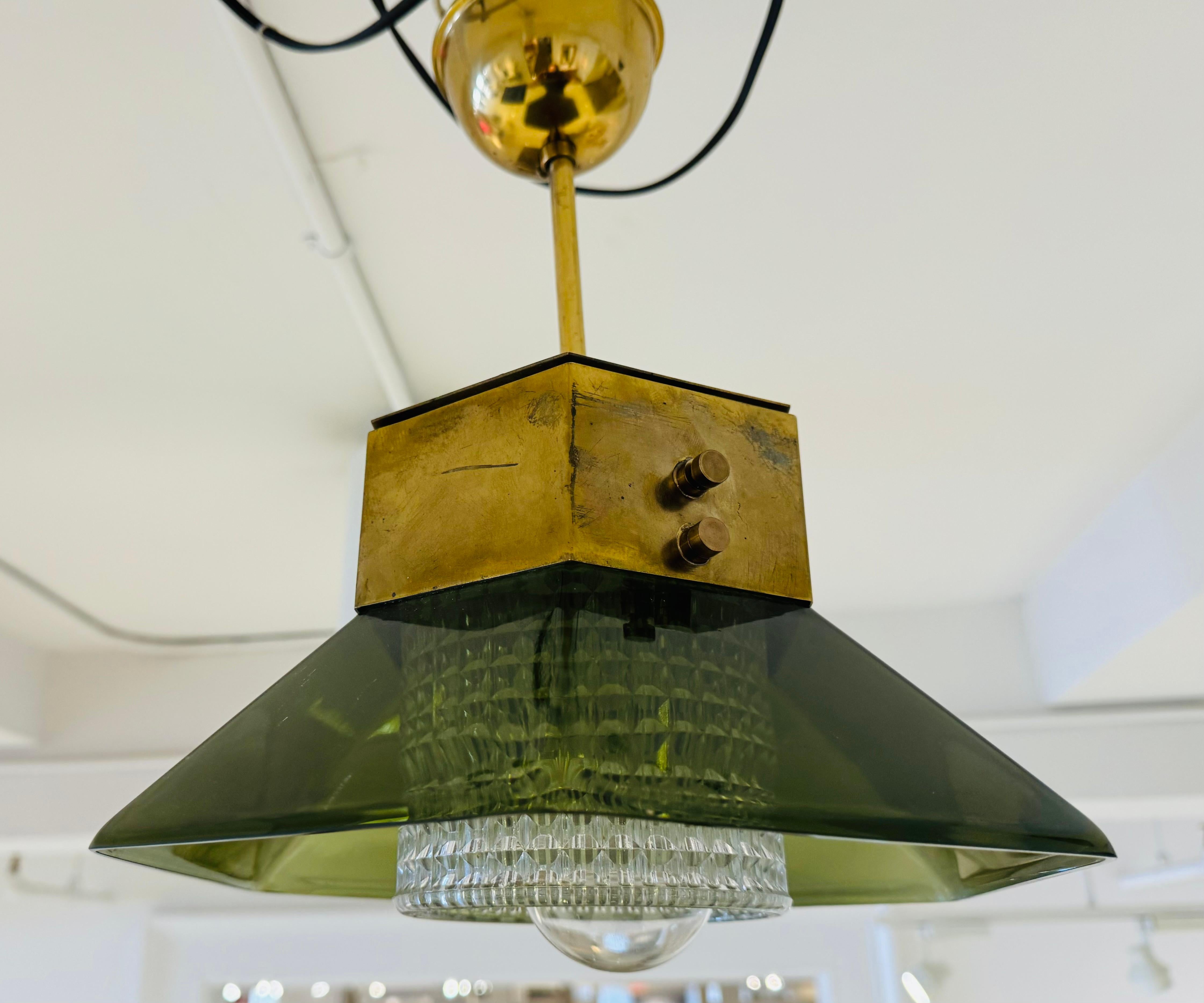 A wonderful small Swedish Mid Century 1960s pendant composed of aged brass hardware and a six sided smoked green glass shade and a clear crystal inter shade. Rewired. 