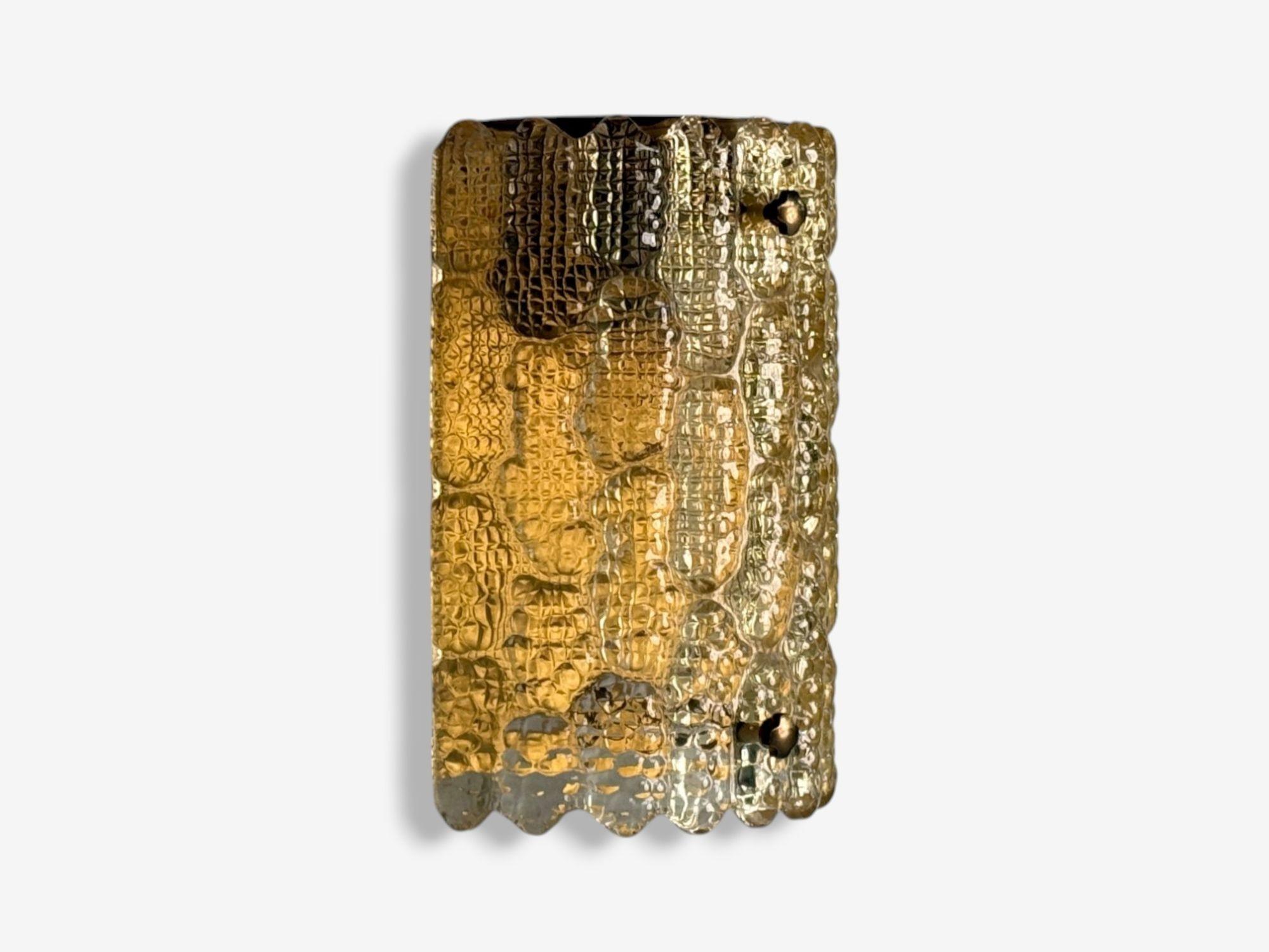 Orrefors, Swedish Modern, Brass, Glass, Wall Light, Sweden, 1960s

Large colored textured glass wall light on a brass backplate designed and produced by Orrefors in Sweden c. 1960s. This fixture has one E26 candelabra socket. Re-wiring is