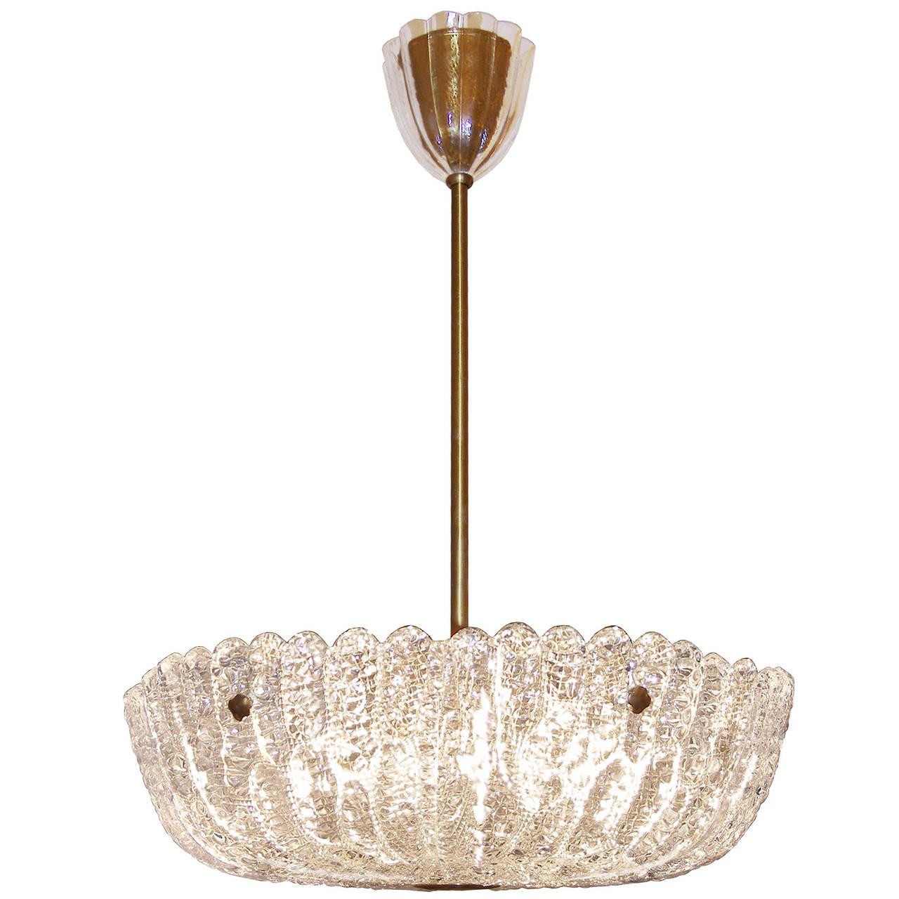 A chandelier consisting of multiple textured crystal panels hung on a brass frame by Orrefors.

Sweden, Circa (two available)

In stock.