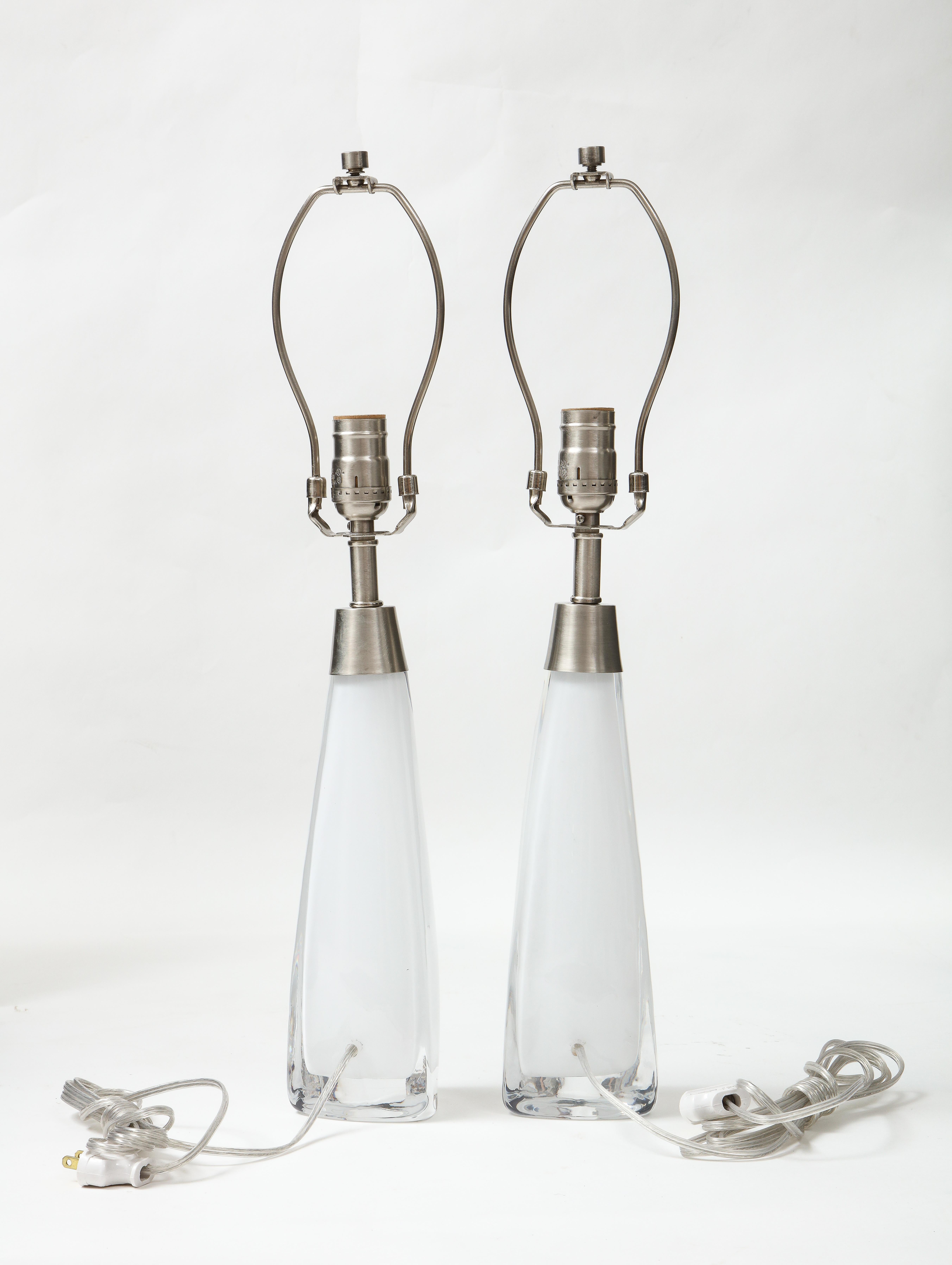 Scandinavian modern pair of white cased crystal lamps with a triangular form base and satin nickel fittings. Rewired for use in the USA, 100W bulbs max.