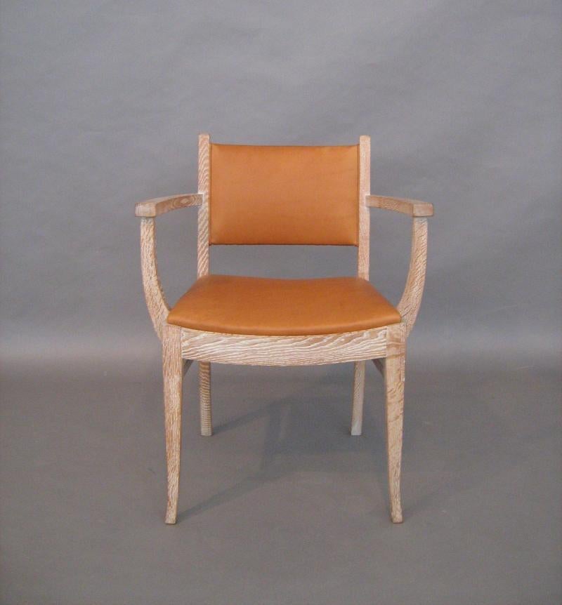 French Art Deco style arm chair interpreted from a classic French Art Deco Ruhlmann design. Elegantly tapered legs and gently curved back and seat. Shown in light cerused oak and saddle leather. Lead time: 8 - 10 weeks.