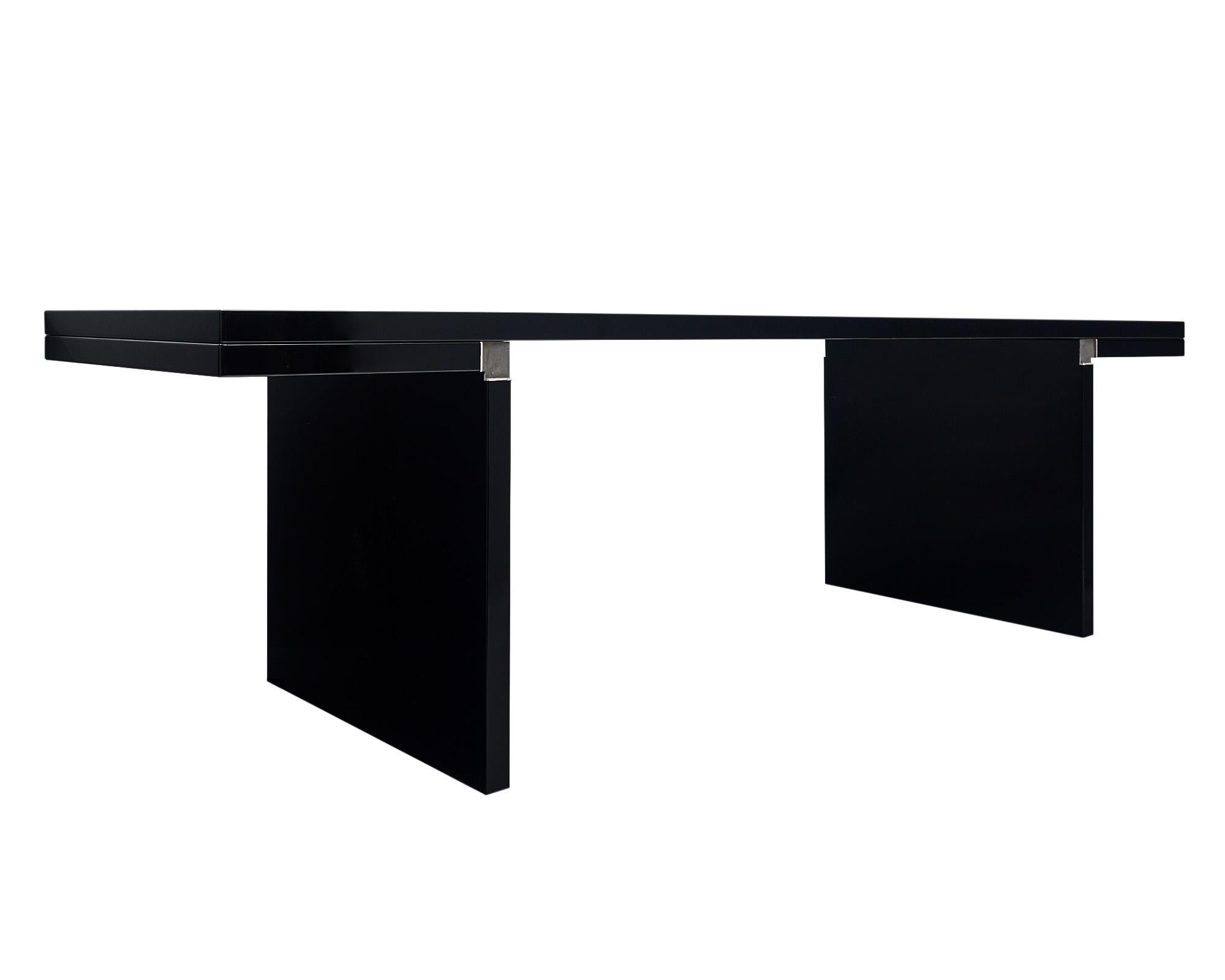 Italian lacquered table by Carlo Scarpa for Cassina. This piece is crafted with MDF panels that have been layered with very shiny mirror-like lacquer. The pieces are assembled using aluminum alloy joints. Carlo Scarpa’s designs are often notable for