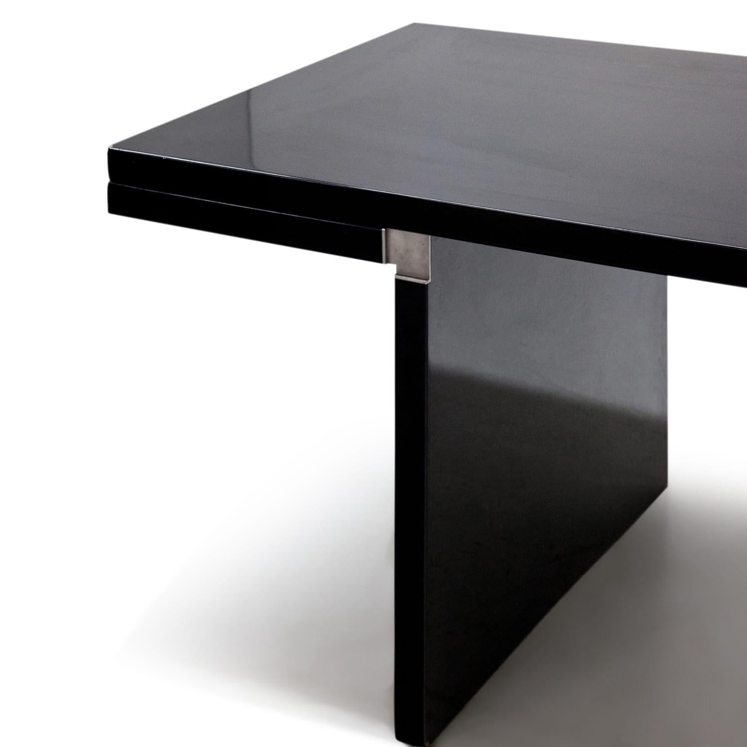 Long rectangular ‘Orseolo’ dining table, designed by Carlo Scarpa in 1972 for Gavina. The completely black table receives its unique and extravagant look through the unusual construction of the inner corners with metal angles. The table is labelled