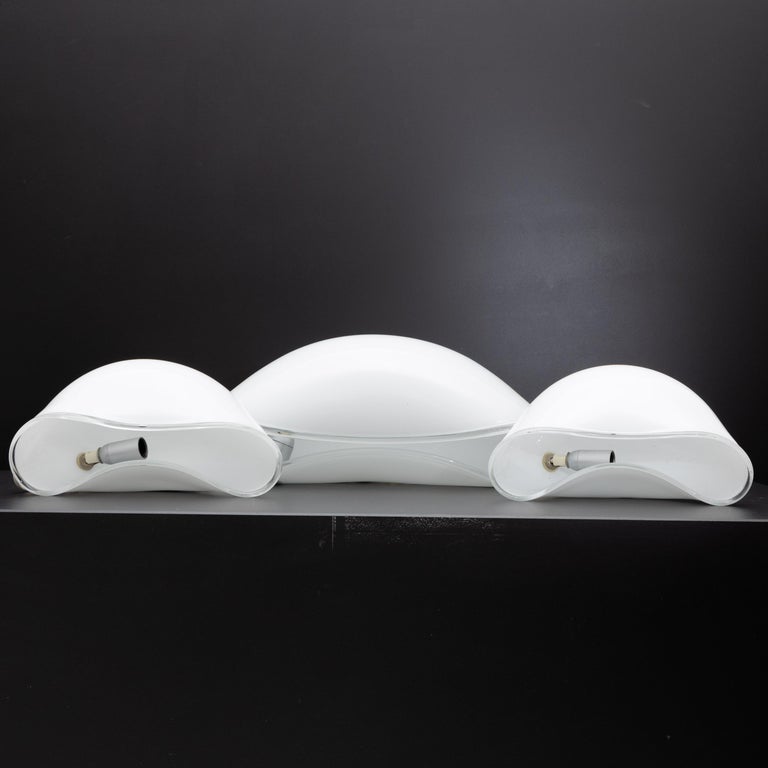 Set of three 'Orsera' table lamps by Vistosi Vetreria from the 1970s. The lamps have a perfectly smooth, hood-shaped frosted glass body accented at the edge by a transparent band. The lamps are unmarked and each is equipped with one burning point.
