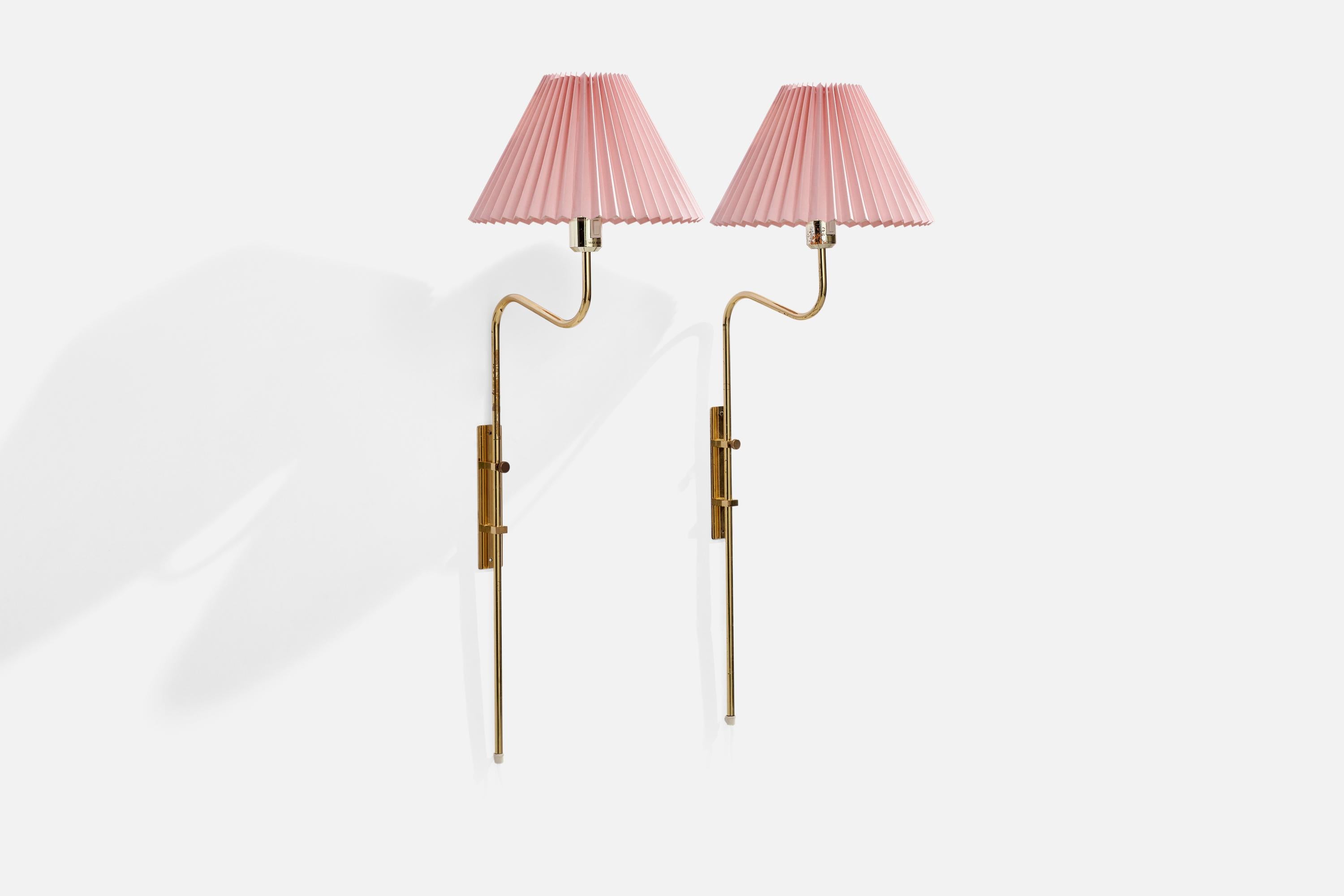 A pair of adjustable brass and pink paper wall lights designed and produced in by Örsjö Industri, Sweden, c. 1970s.

Please note lamps function via plug in, with cords feeding from bottom of stems.

Overall Dimensions (inches): 37” H x 12” W x
