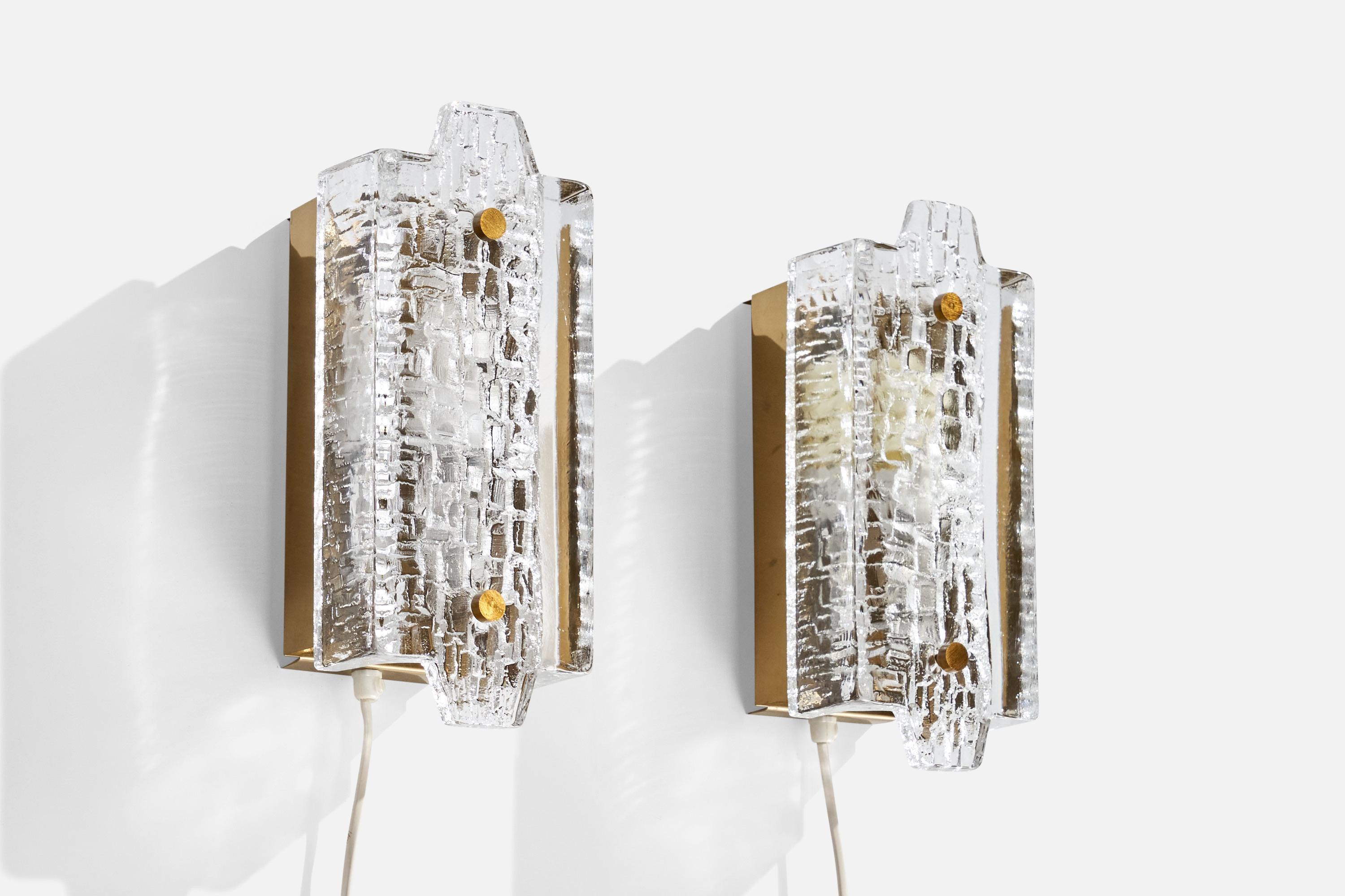 A pair brass and glass wall lights designed and produced in Sweden, c. 1970s.

Overall Dimensions (inches):  10.75” H x  4.375” W x  4.25“D
Back Plate Dimensions (Inches):  8.125” H x 3.875” W x 1.5” D
Bulb Specifications: E-26 Bulbs
Number of