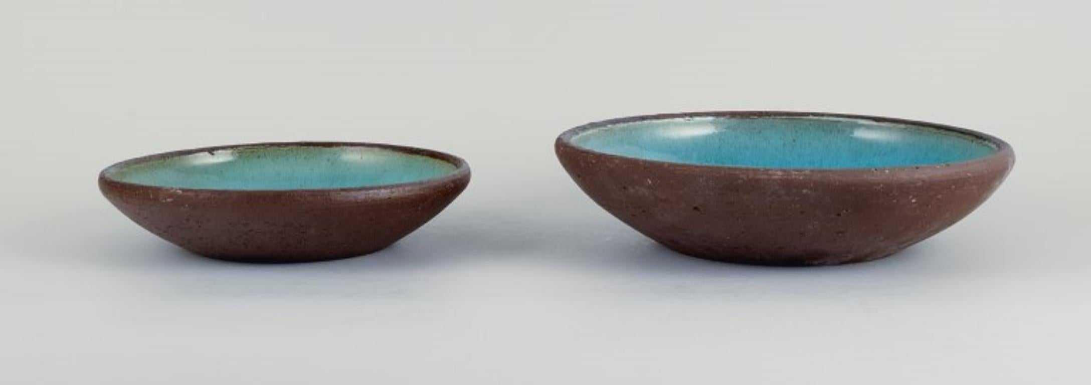 OSA, Denmark.
Two large retro unique ceramic bowls with glaze in turquoise tones.
1970s.
In perfect condition.
Largest measurement: D 23.5 x H 6.0 cm.

OSA was a collaboration between Aase Feilberg, Chr. Frederiksen and Gutte Eriksen.