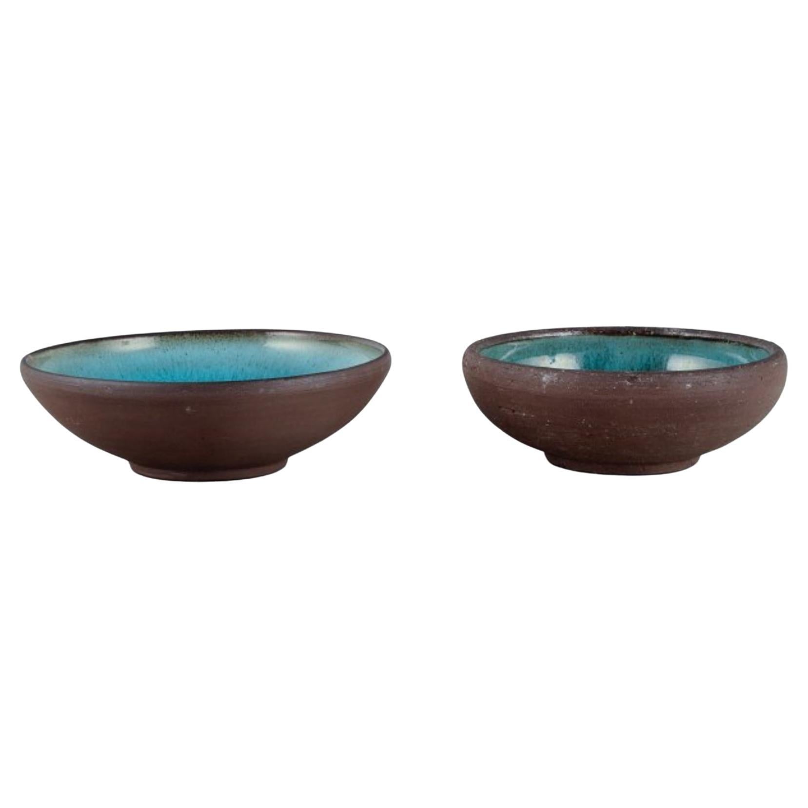 OSA, Denmark.
Two small retro unique ceramic bowls with glaze in turquoise tones.
1970s.
In perfect condition.
Largest measurement: D 14.0 x H 4.5 cm.

OSA was a collaboration between Aase Feilberg, Chr. Frederiksen and Gutte Eriksen.