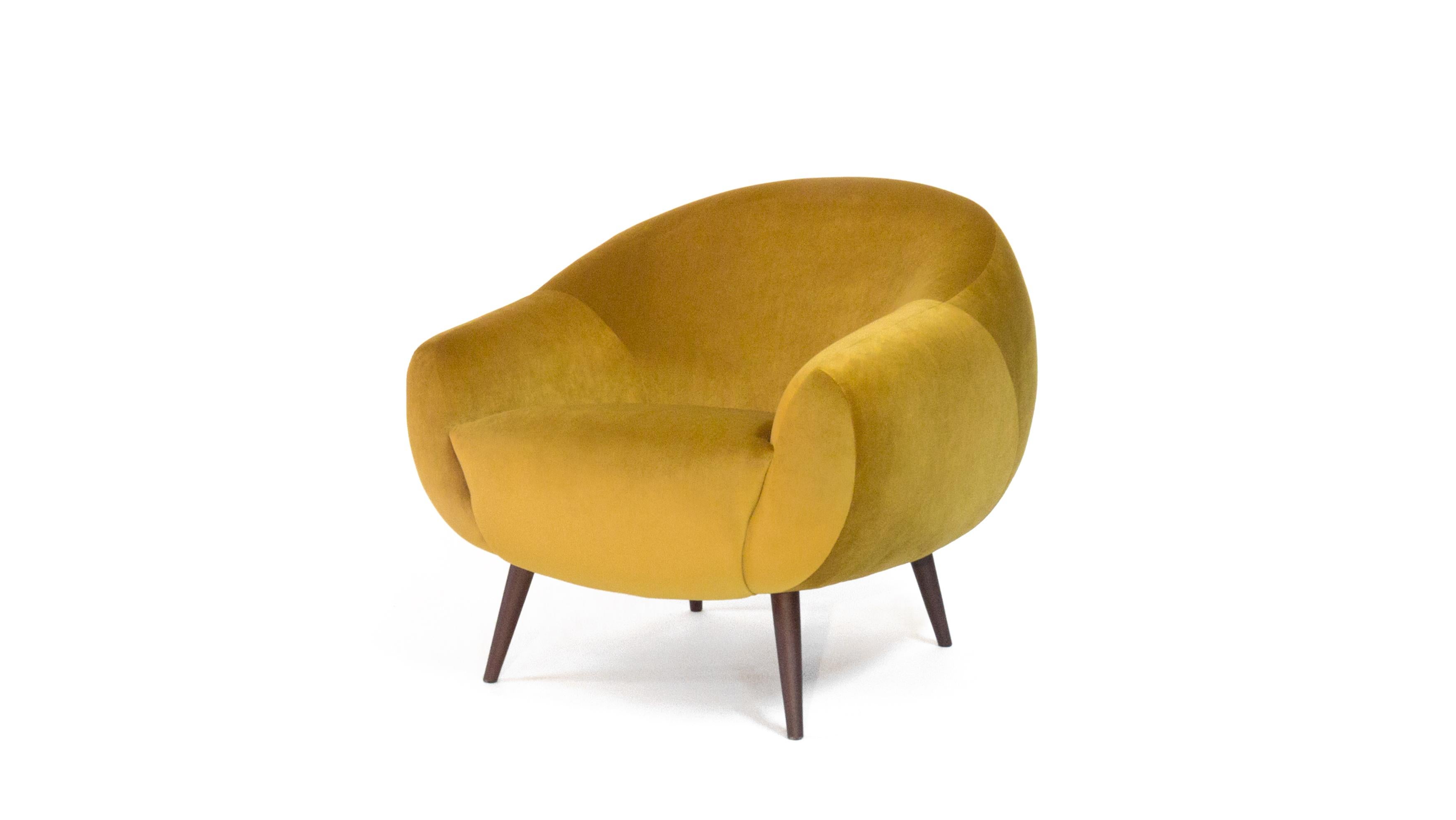 The rounded lines of this early 1950s style armchair are influenced by the 