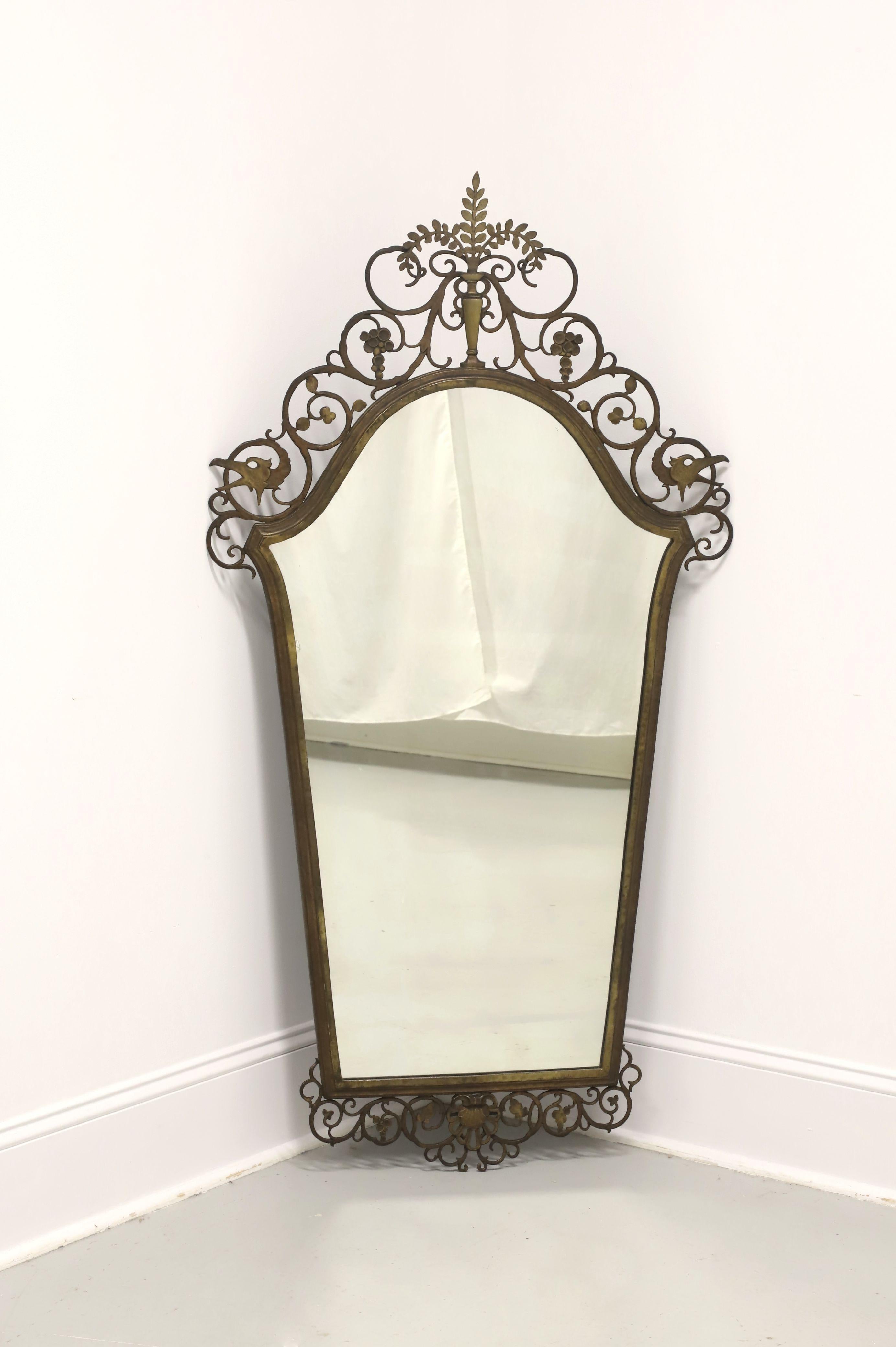 An antique Art Deco style wall mirror by Oscar Bach. Mirrored glass in a decorative bronze metalwork frame. Features a tapered shape, an arched top, and an ornately sculpted bird & foliage fretwork motif. Made in the USA, circa 1920's.

Measures: 
