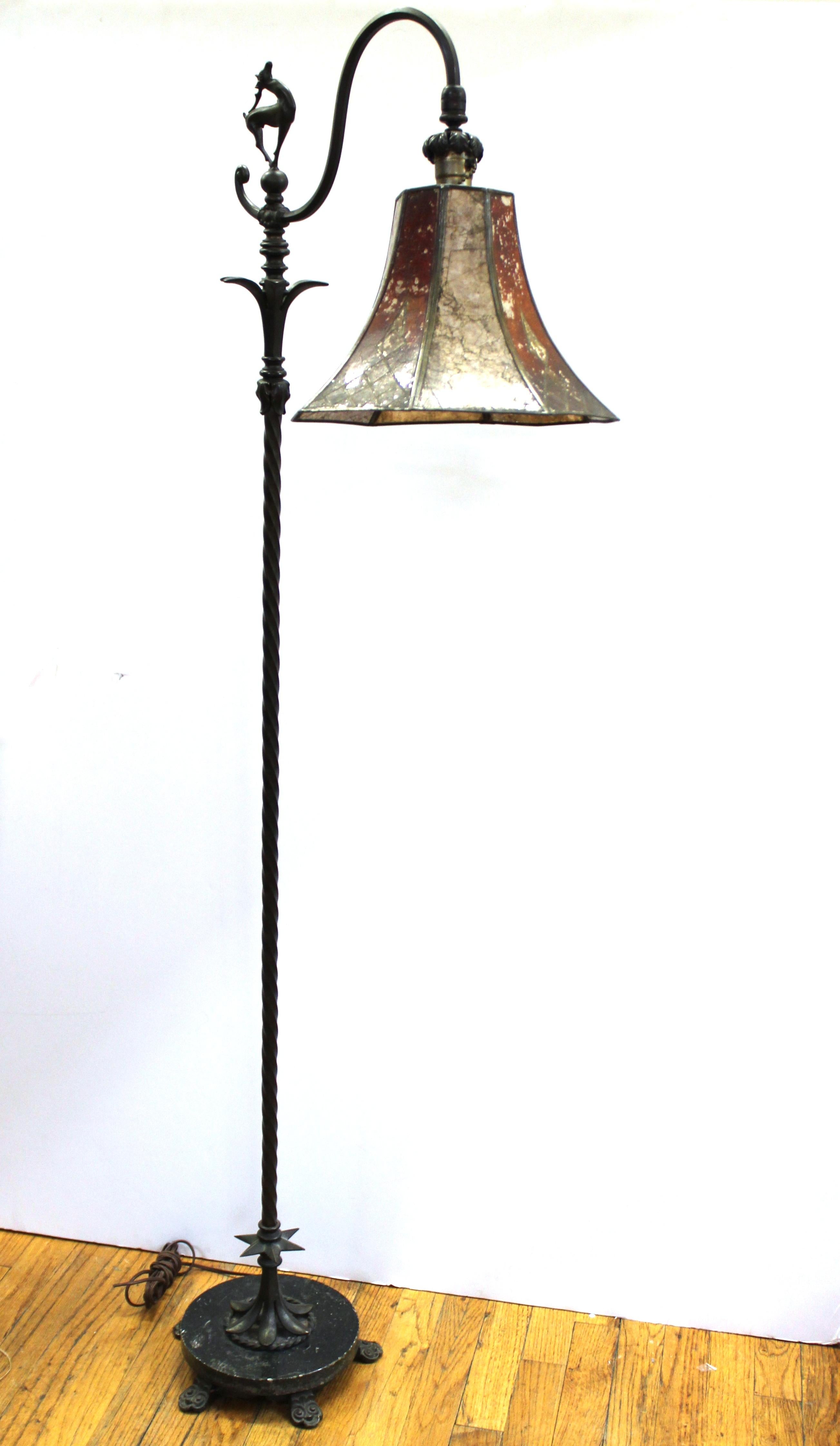 Art Deco bronze and mica floor lamp by Oscar Bach, dating from the circa 1920s, with a detailed figure of a deer on top of the torsaded stem, on top of a rounded green marble base. The piece retains its original mica shade and is in great vintage