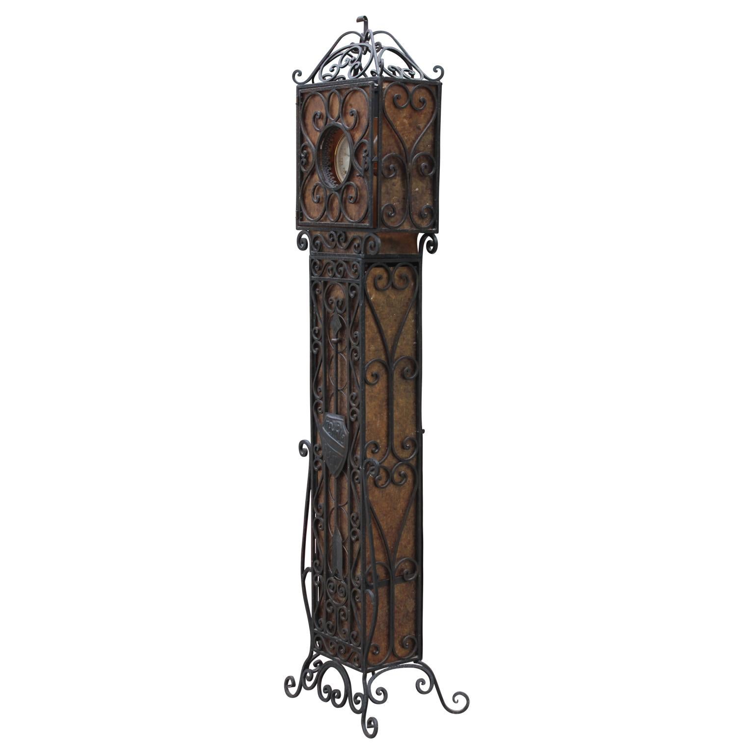 A beautiful crafted wrought iron and mica light up stand up clock attributed to Oscar Bach. As you pay attention to the intricate detailing and design, you will realize this clock will serve as a lovely statement piece in any room