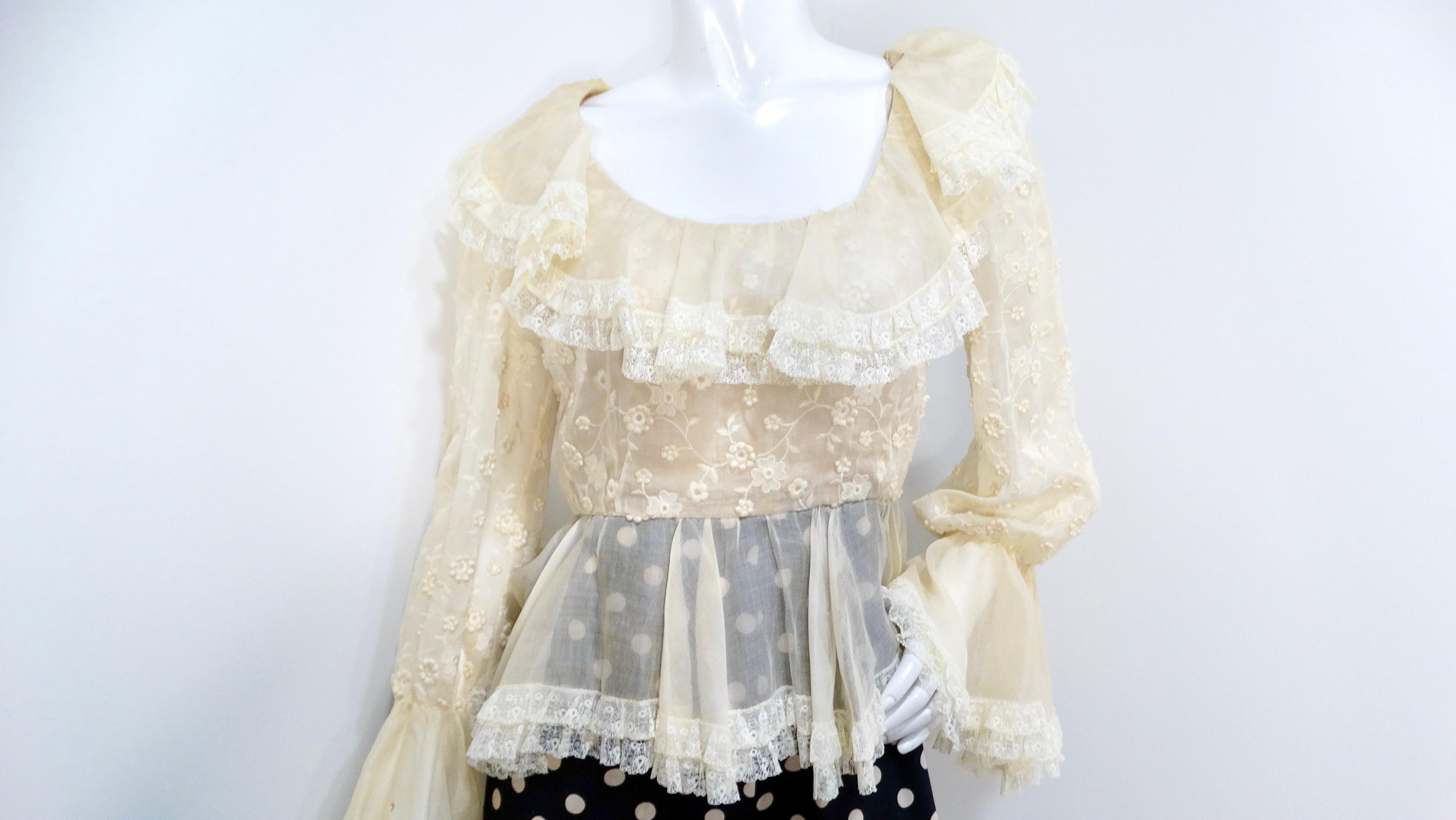 The Oscar De La Renta 1980s Sheer Lace and Polka Dot Jumpsuit is a stunning embodiment of vintage glamour and sophisticated style. The top features a delicate cream sheer blouse, adorned with exquisite floral stitching and intricate lace detailing