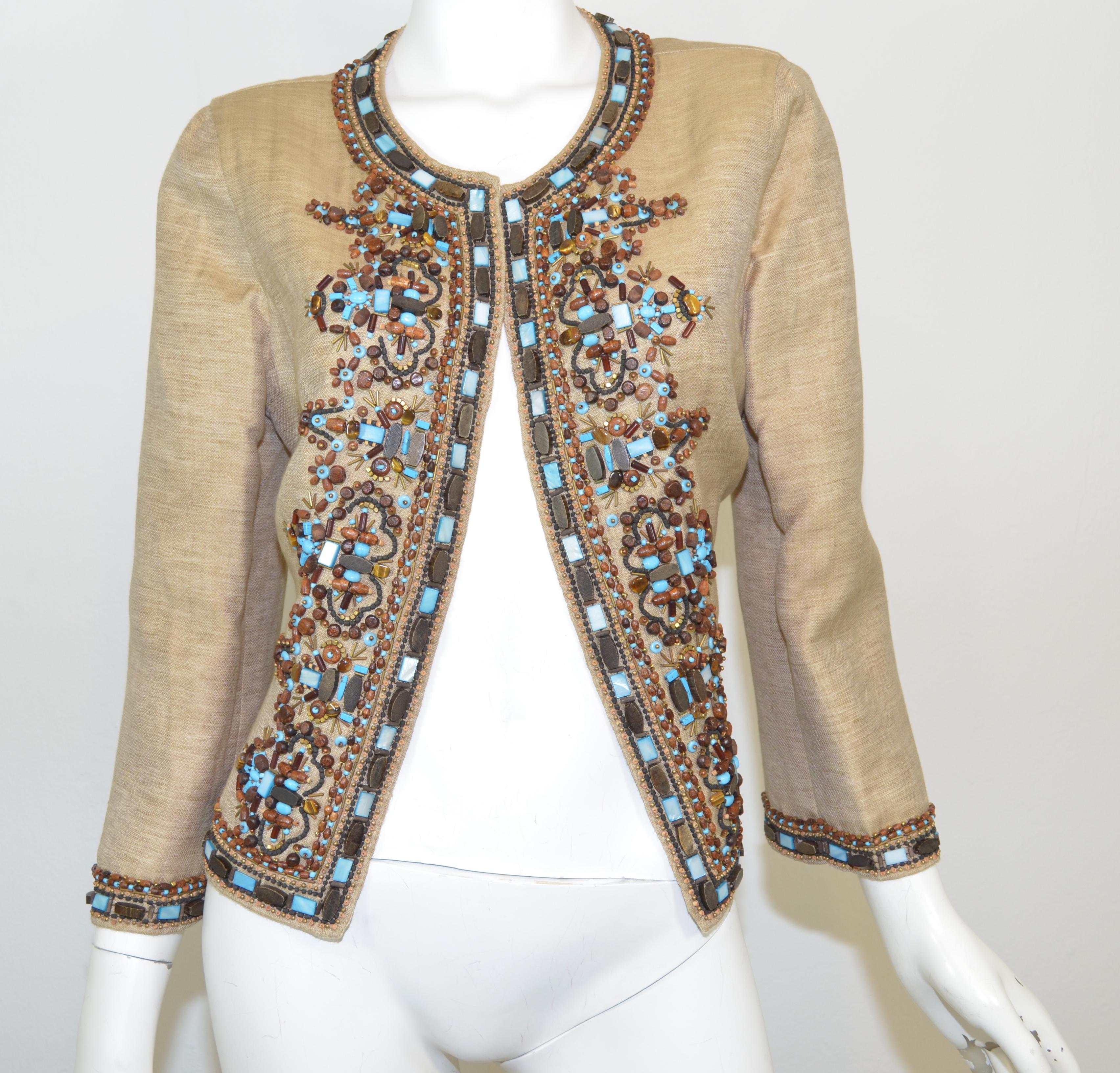 This Oscar de la Renta jacket is beautifully embellished with a mix of beads that border the jacket and cover the bust. Jacket has a single hook and eye fastening. Size 12, made in Italy.

Measurements:
Bust 40”
Sleeves 21”
Shoulder to shoulder