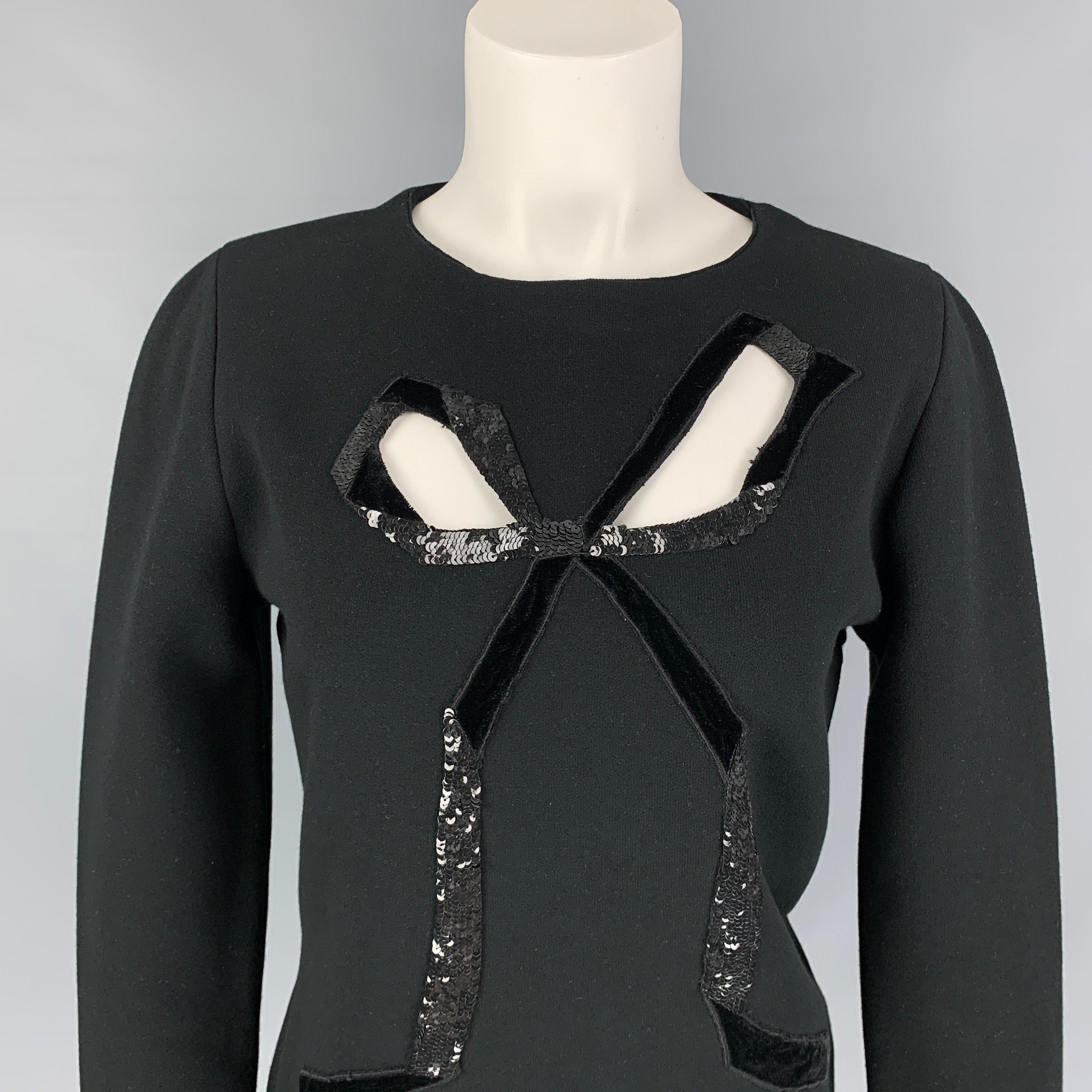 OSCAR DE LA RENTA 2021 pullover comes in a black viscose blend featuring a front cut-out bow design, sequin trim, and a crew-neck.
Very Good
Pre-Owned Condition. 

Marked:   L  

Measurements: 
 
Shoulder: 15.5 inches  Bust: 36 inches  Sleeve: 27