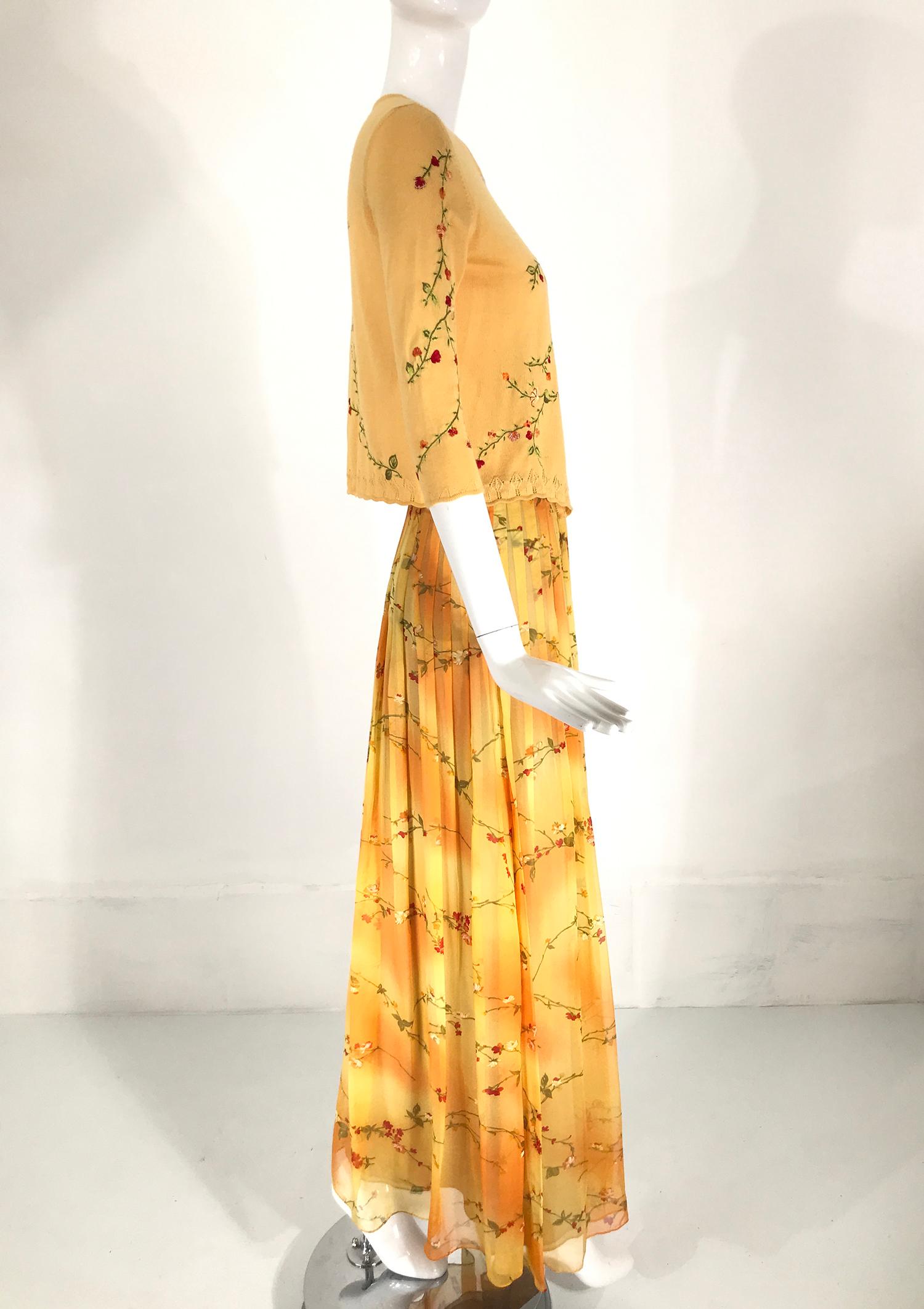 Oscar de la Renta 2pc embroidered cropped cashmere/silk sweater and coordinating printed silk maxi skirt. The yellow sweater has a single button closure at the neck front, elbow length sleeves and is cropped to the waist, embroidered with green