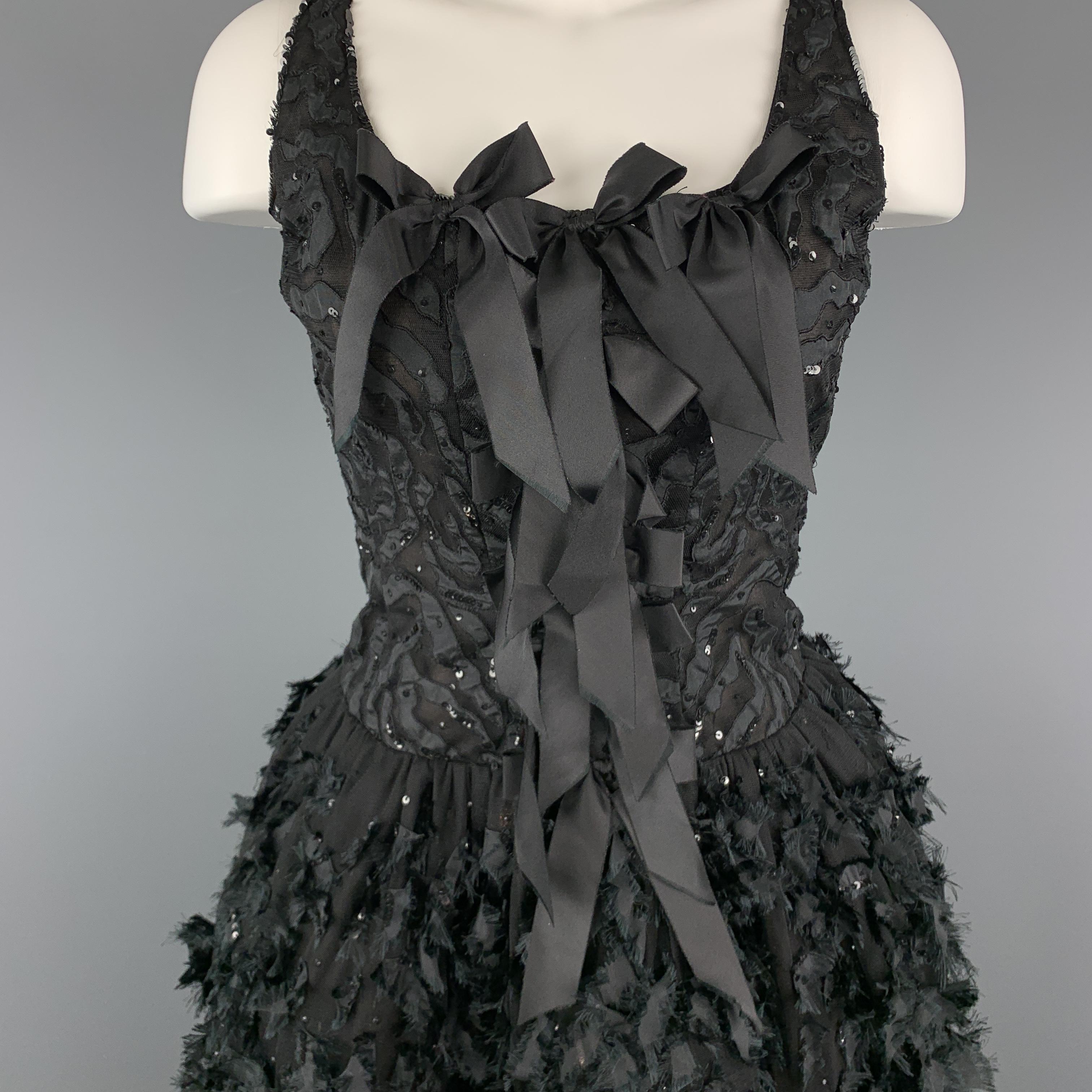 Sleeveless OSCAR DE LA RENTA cocktail dress features a tiger pattern sequin burnout tulle bodice with bow accents, and bubble skirt with frayed ribbon appliques. Circa 2008. Made in USA.

Very Good Pre-Owned Condition.
Marked: