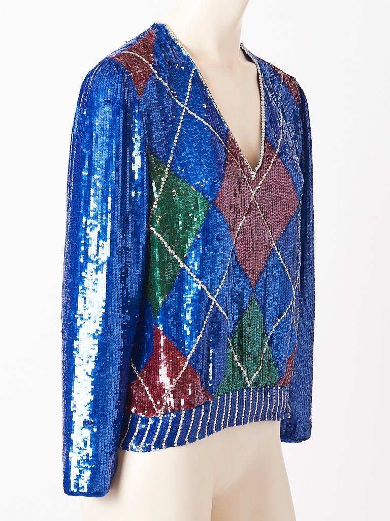 Oscar de la Renta, argyle pattern, long sleeve, v neck top, encrusted with multi tone sequins and rhinestone detail . Top has Sapphire blue background with a chiffon lining.