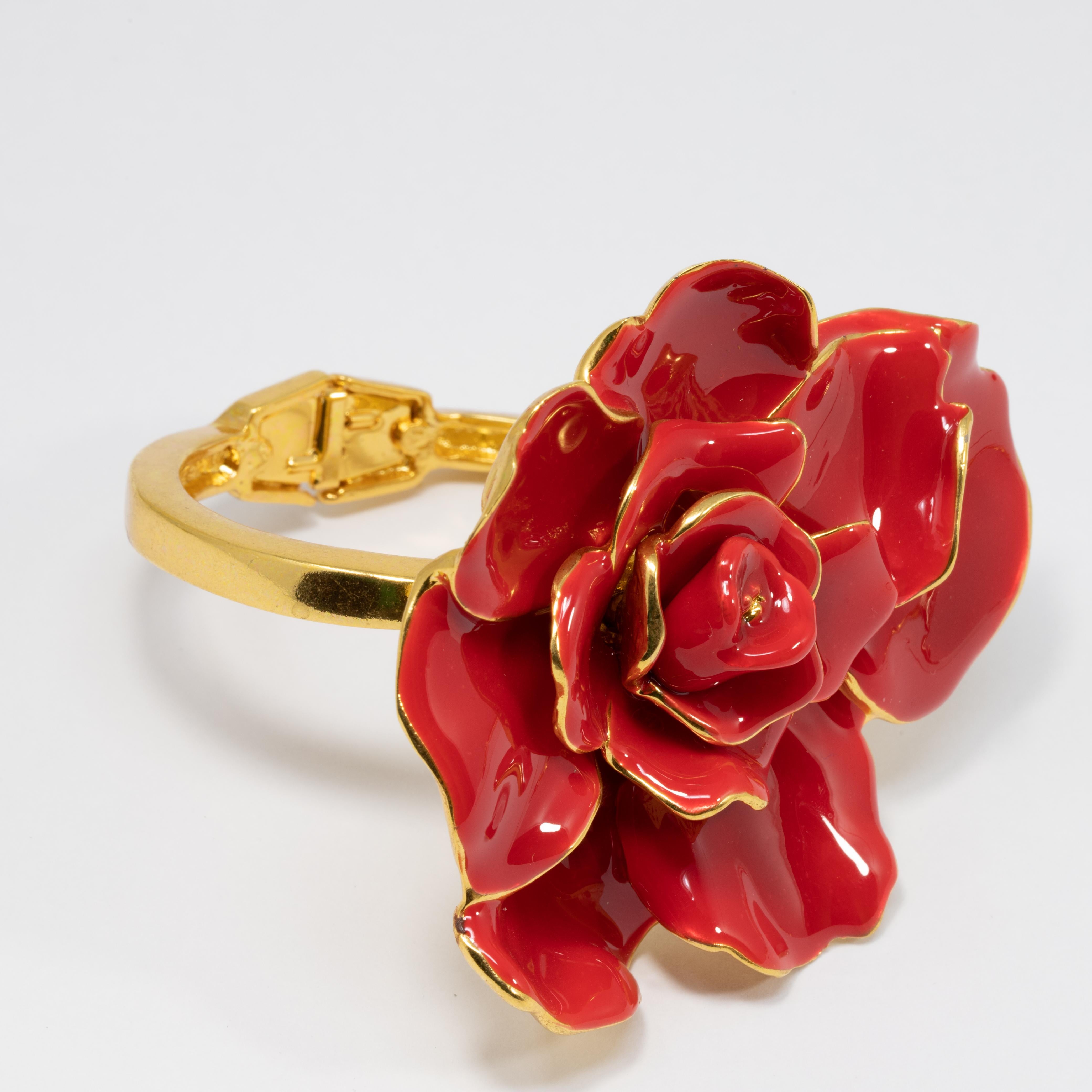 A bold and bright painted red enamel rose rests on this stunning Oscar de la Renta bracelet. An extravagant accessory perfect for any style!

Hinged magnetic closure
16cm inner circumference
5.5cm inner diameter at widest part
