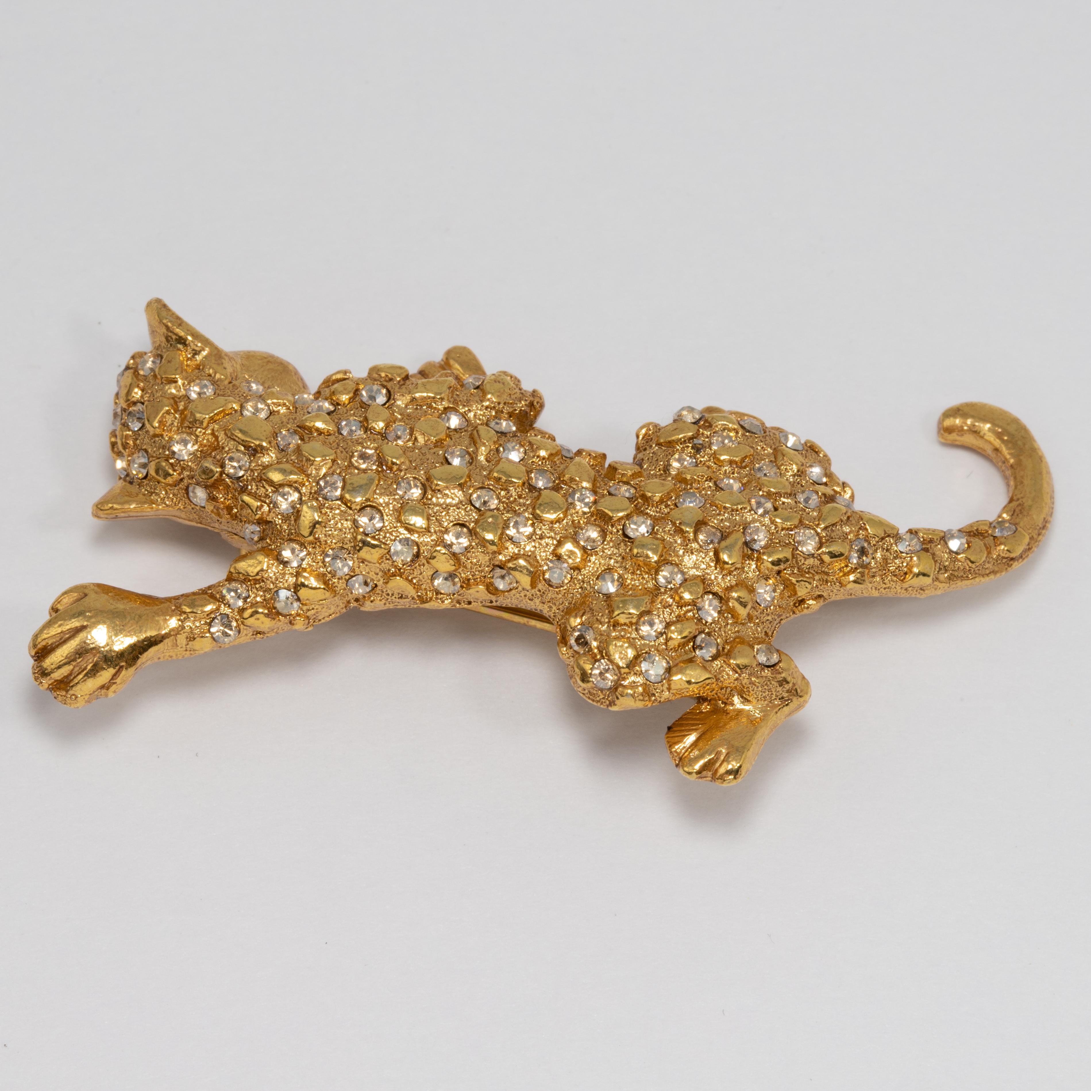 An embellished leopard pin brooch by Oscar de la Renta. This gold-tone wildcat is decorated with black diamond Swarovski crystals.

Hallmarks: Oscar de la Renta, Made in USA