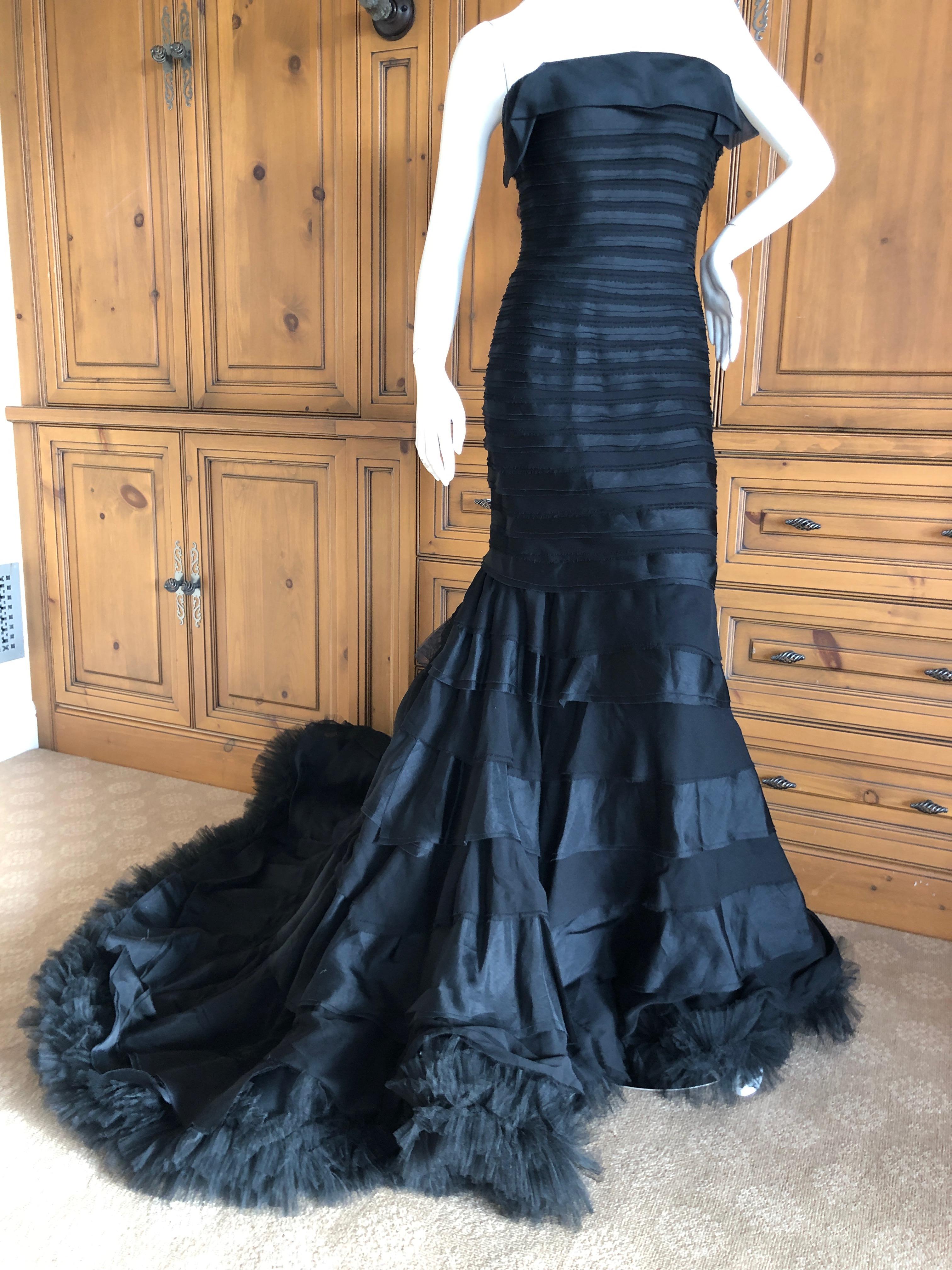 Oscar de la Renta Black Flamenco Ruffled Ballgown with Grand Train
There is an inner bustier.
Simply Stunning. Please use the zoom feature to see al the remarkable details.
Size 8
 Bust 34