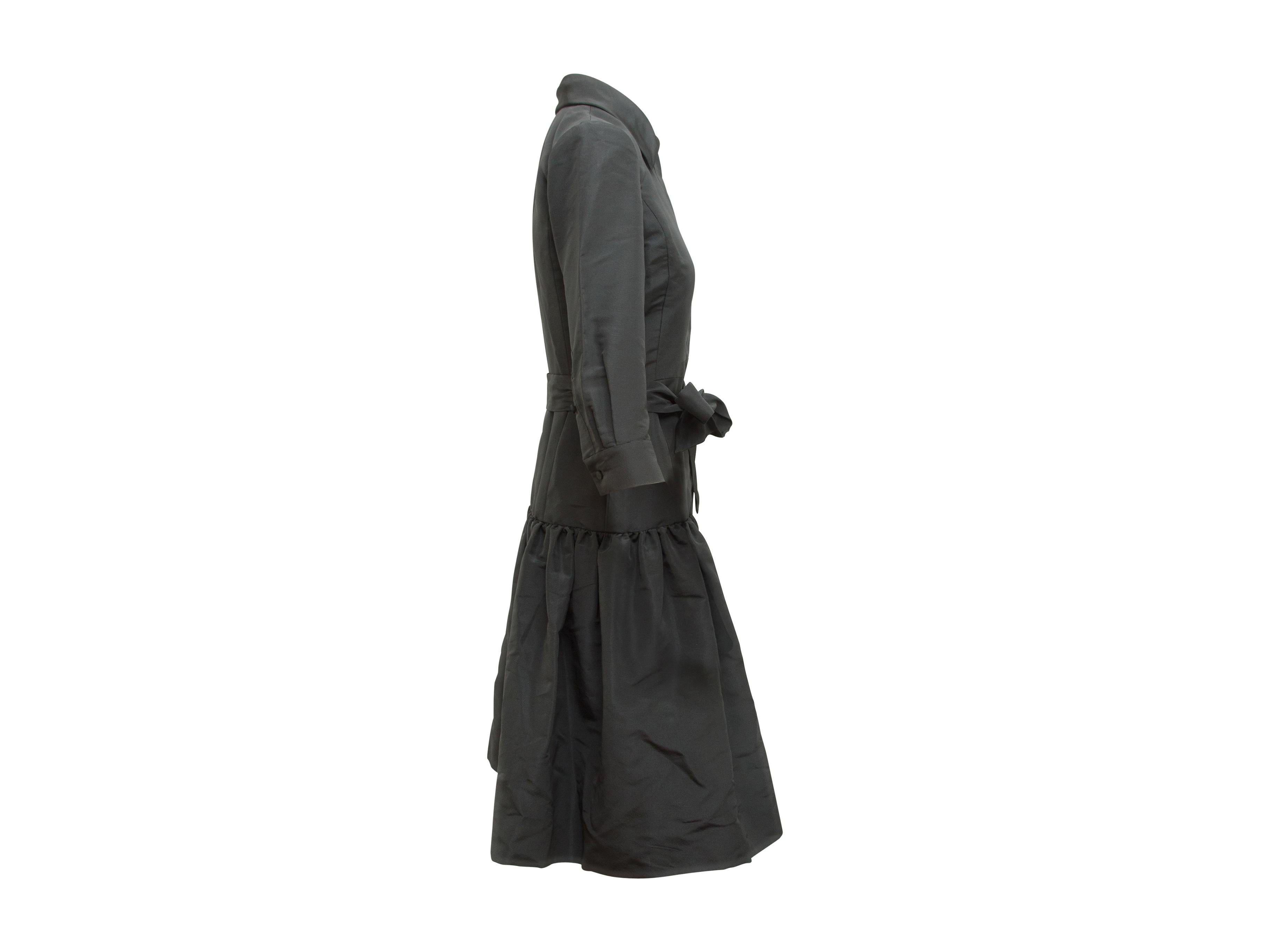 Product details:  Black drop-waist dress by Oscar de la Renta.  From the FW 2009 collection.  Spread collar.  Three-quarter length sleeves.  Two-button detail at cuffs.  Concealed button-front closure.  Self-tie belted waist.  36