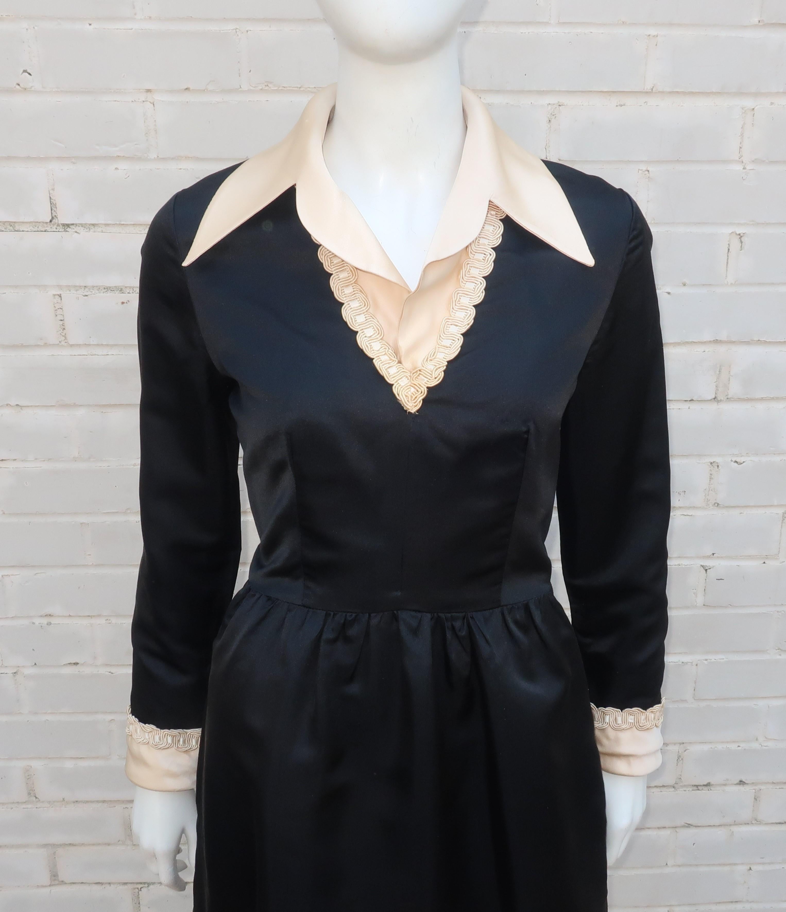 1970's Oscar de La Renta black & ivory satin cocktail dress with a demure silhouette and decidedly chic look.  The dress zips and hooks at the back with hidden side pockets and braiding at the neckline and cuffs.  The two tone design presents the