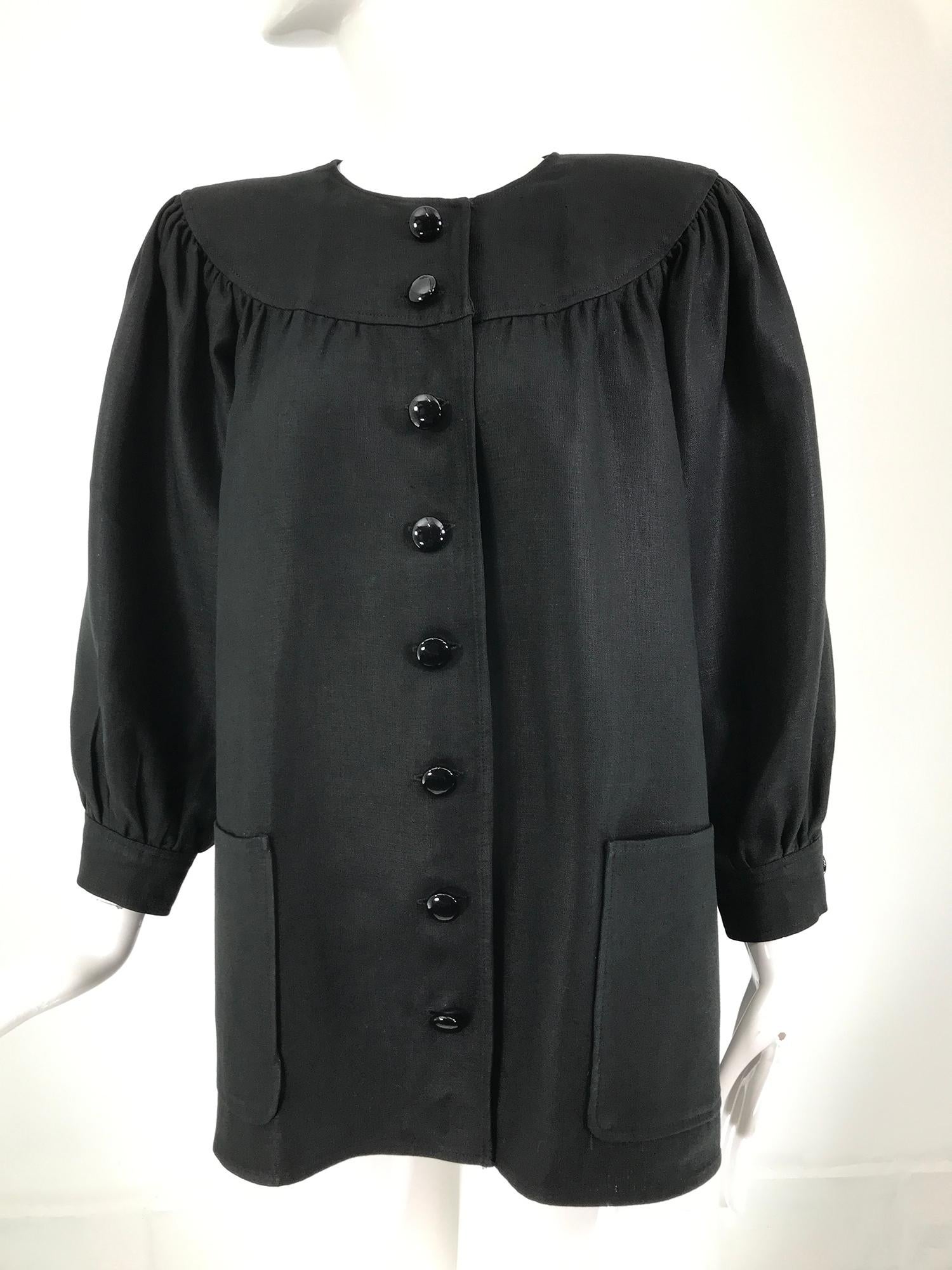 Oscar de la Renta heavy black linen button front, full sleeve jacket with patch pockets from the 1980s. Jewel neck jacket has a deep curved yoke neckline front & back, long full raglan sleeves with button band cuffs, the jacket has padded shoulders.