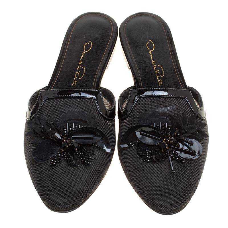 You'll love walking in these slides all day long for they are born to enchant! These Oscar de la Renta black slides feature mesh toes and vamps that are embellished with a floral motif. In an open back design, they come equipped with comfortable