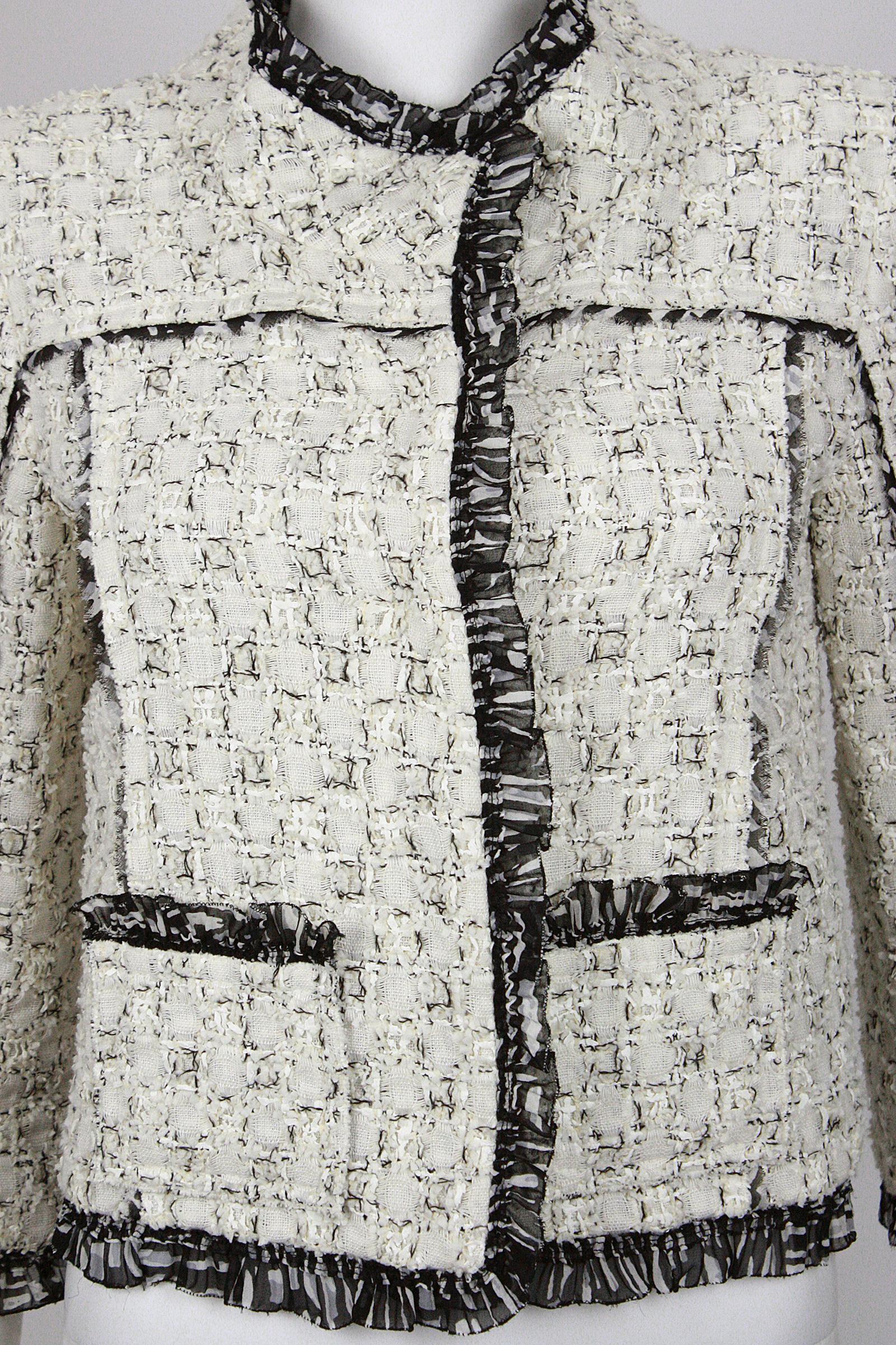 Oscar de la Renta 
Crop jacket
Black & white
Unique cotton blend textile
Ruffled chiffon detailing
Bracelet length sleeves
Two front pockets
Snap closures
Silk lining