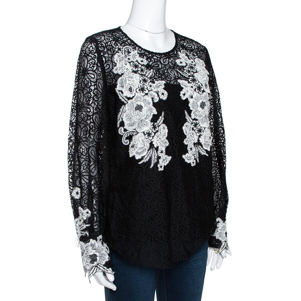 Oscar de la Renta's blouse in classic black hue exudes confidence and style in equal measure. It is made of 100% nylon with silk lining that gives it a gleaming finish and comfortable fit. It comes with feminine floral lace detail at the front and