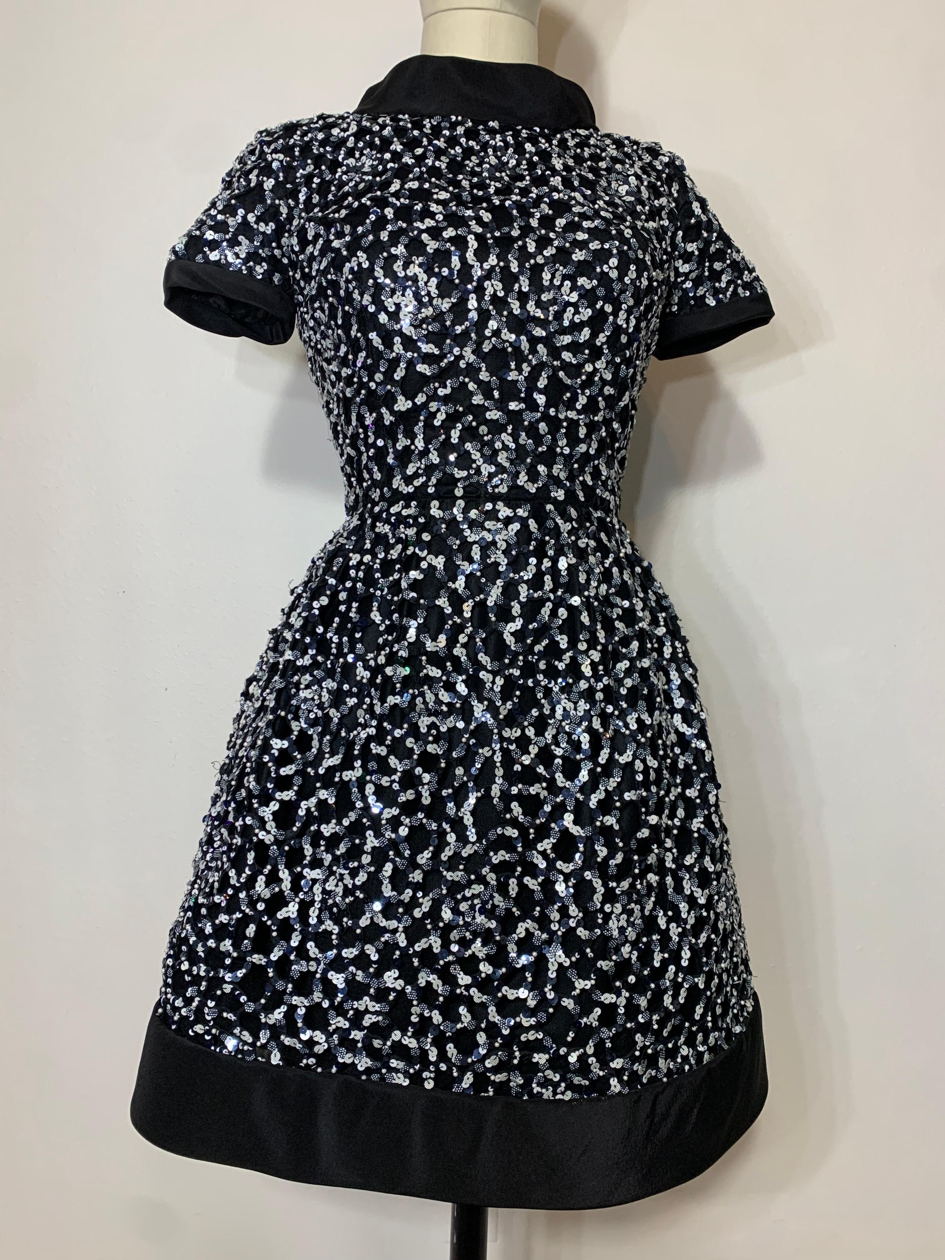 Oscar de la Renta Black & White Sequin Bell-Shaped Mini Cocktail Dress:  This Belle Du Jour-inspired structured silk faille dress is meant to have a crispy silhouette with its banded collar, cuffs and hem for a mod 60s vibe. Unusual textured and