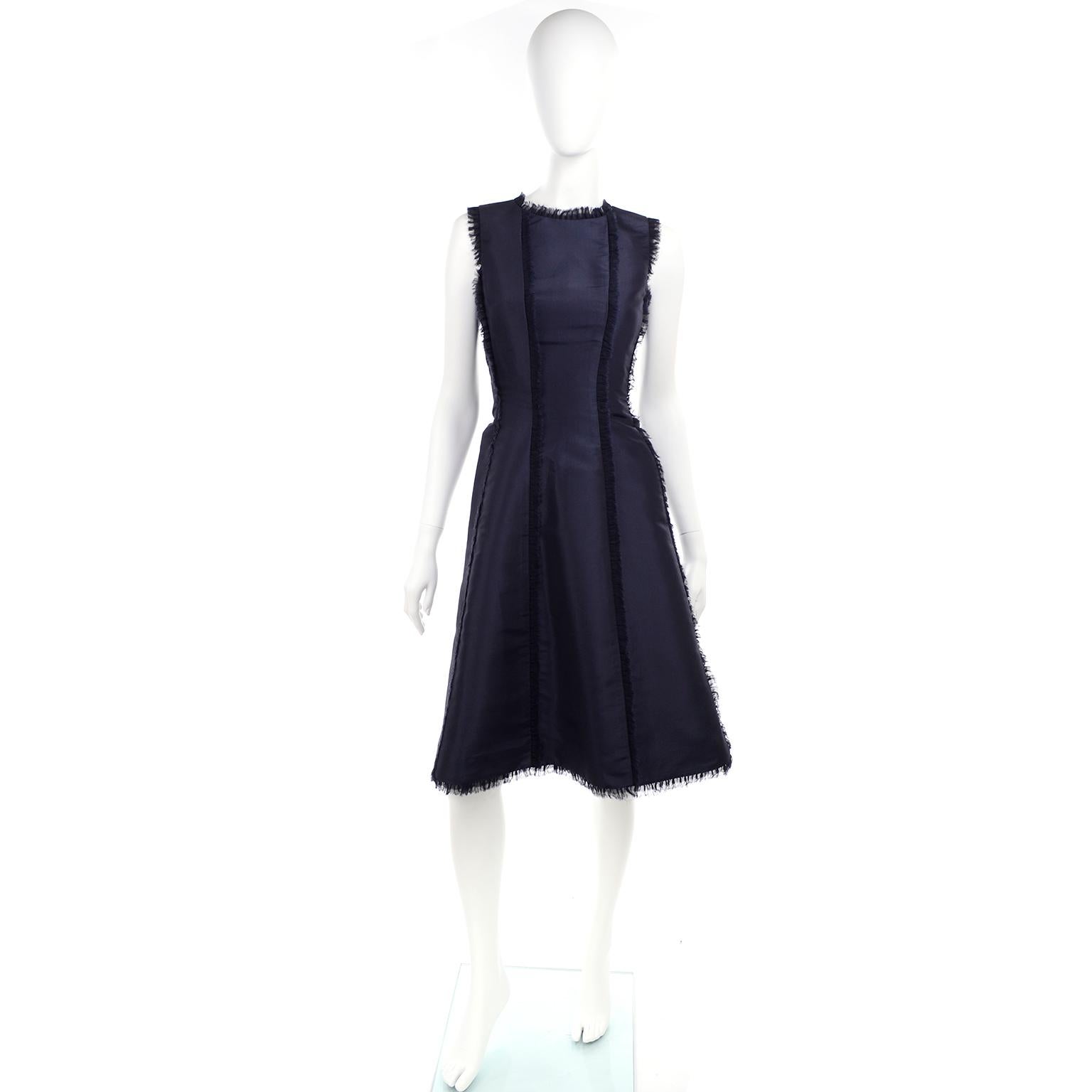 This is a gorgeous Oscar de la Renta rich lush blue silk dress. This perfectly structured dress is sleeveless, with eyelash frayed edges and exposed frayed seam detailing. We think it would make the perfect evening dinner dress or even a great