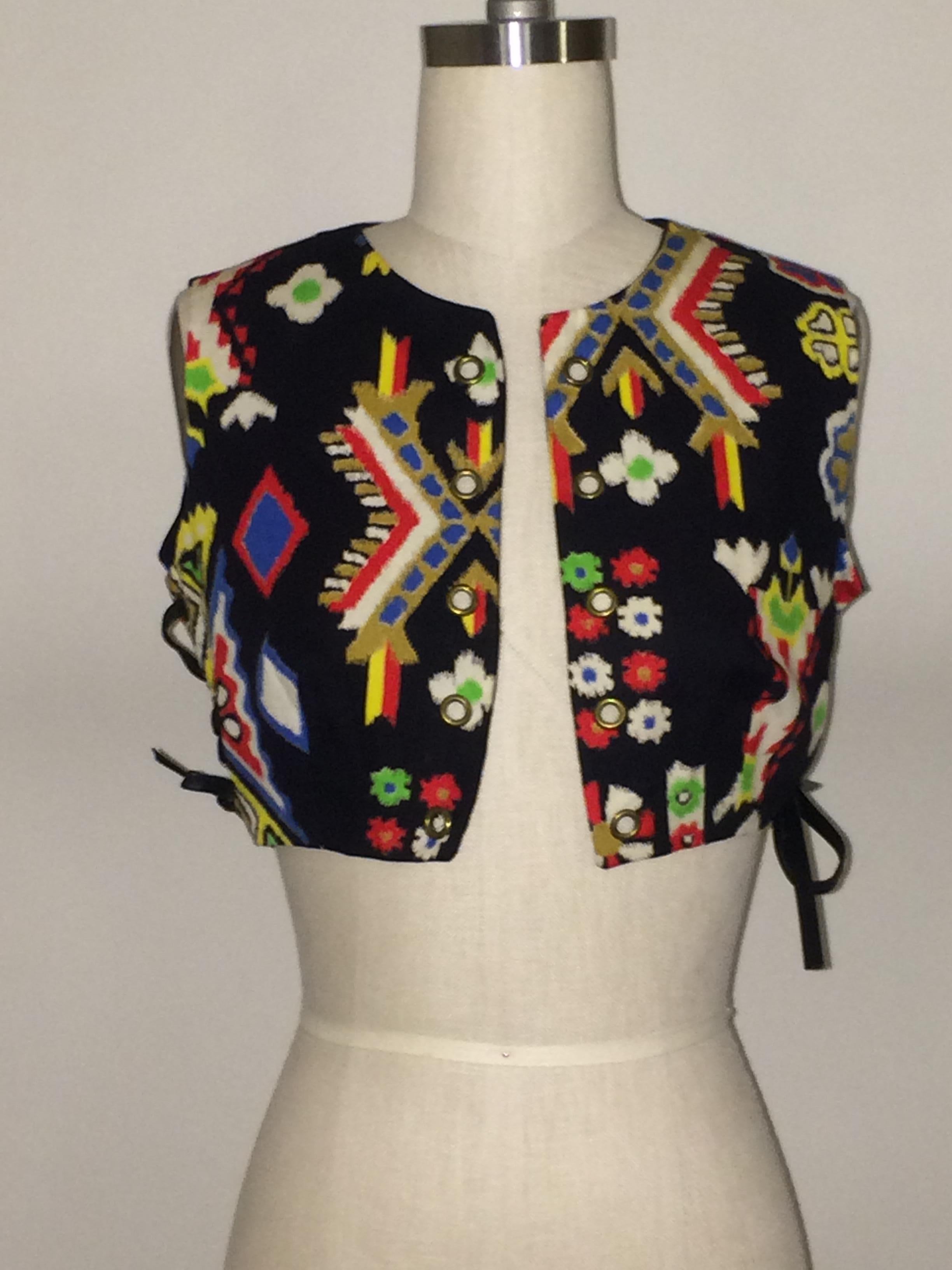 Oscar de la Renta Boutique vintage 1970's ethnic print vest with six grommets at side featuring black leather lacing. Can tie strings in bows or let them hang. Decorative grommets at front. 

Works really well over a maxi dress, or with a tank and