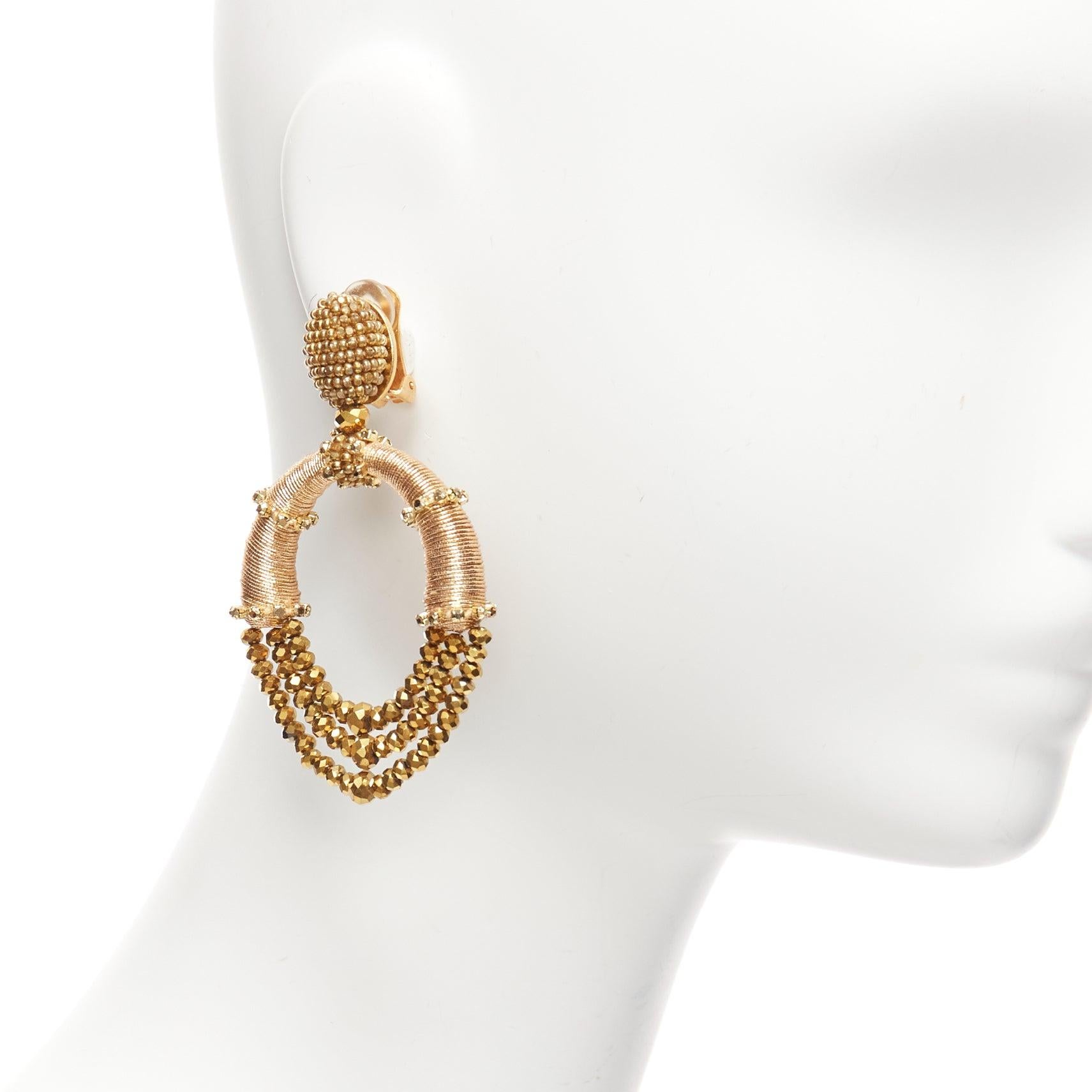 OSCAR DE LA RENTA bronze gold beaded coil big hoop dangling clip on earrings pair
Reference: AAWC/A01055
Brand: Oscar de la Renta
Material: Metal, Acrylic
Color: Gold, Bronze
Pattern: Solid
Closure: Clip On
Lining: Gold Metal
Made in: