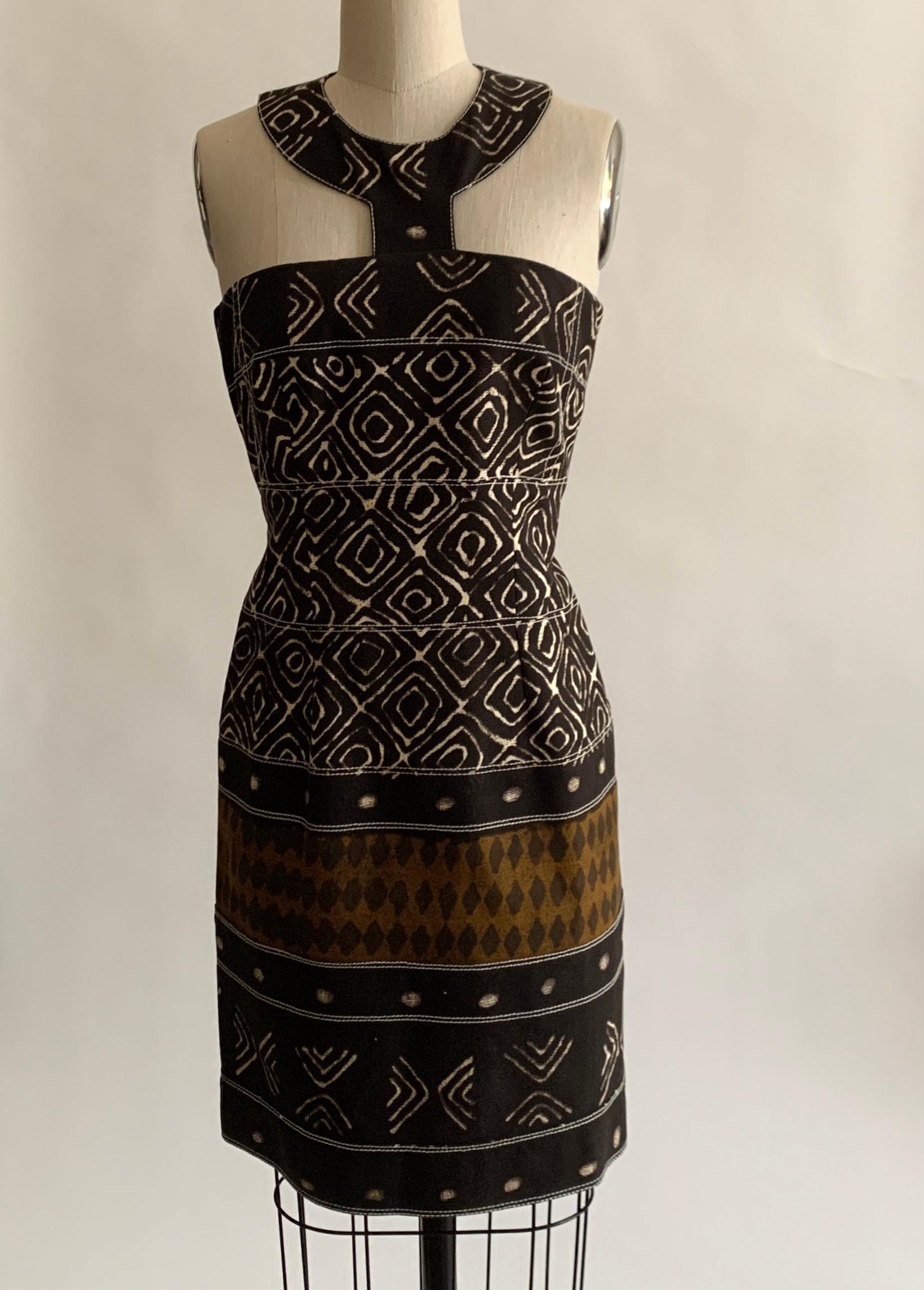 Oscar de la Renta brown and ivory tribal ikat batik print sleeveless pencil dress with harness style halter collar. Light boning at bust creates great shape. Back zip, hook and snap closures with hook and snap closures at back neck.

As seen on the