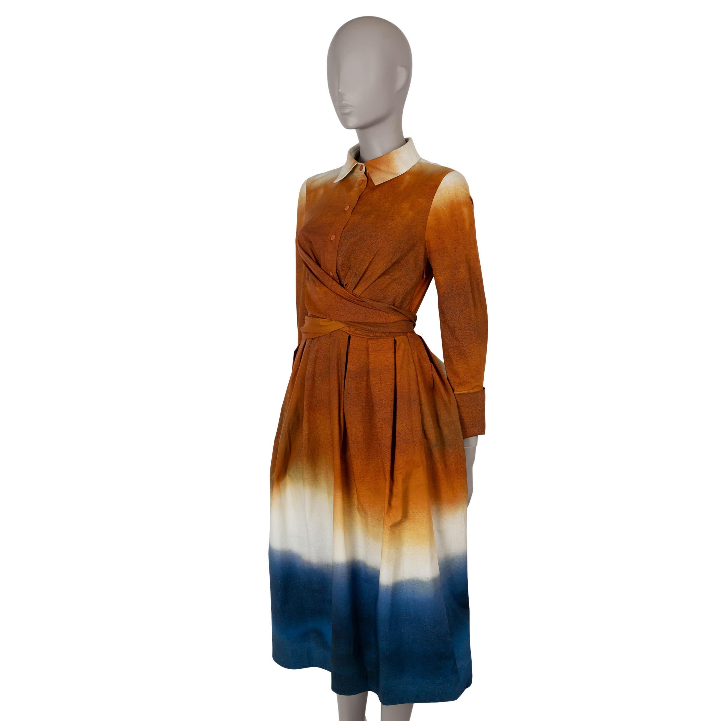 This 100% authentic Oscar de la Renta wrap-effect shirt dress is crafted from Canyon brown and navy blue poplin cotton (with 3% elastane) for a structured yet comfortable fit. It features a fit-and-flare silhouette with a midi length, designed with