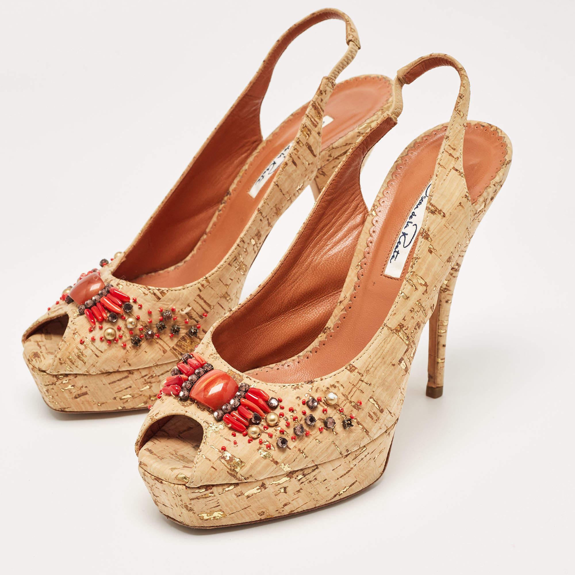 A classic design never fails to impress nor does it go out of style. Oscar De La Renta takes the classic design of the simple pump and embellished it with an open toe and a slingback elastic detail. The body is embellished with beads to create a