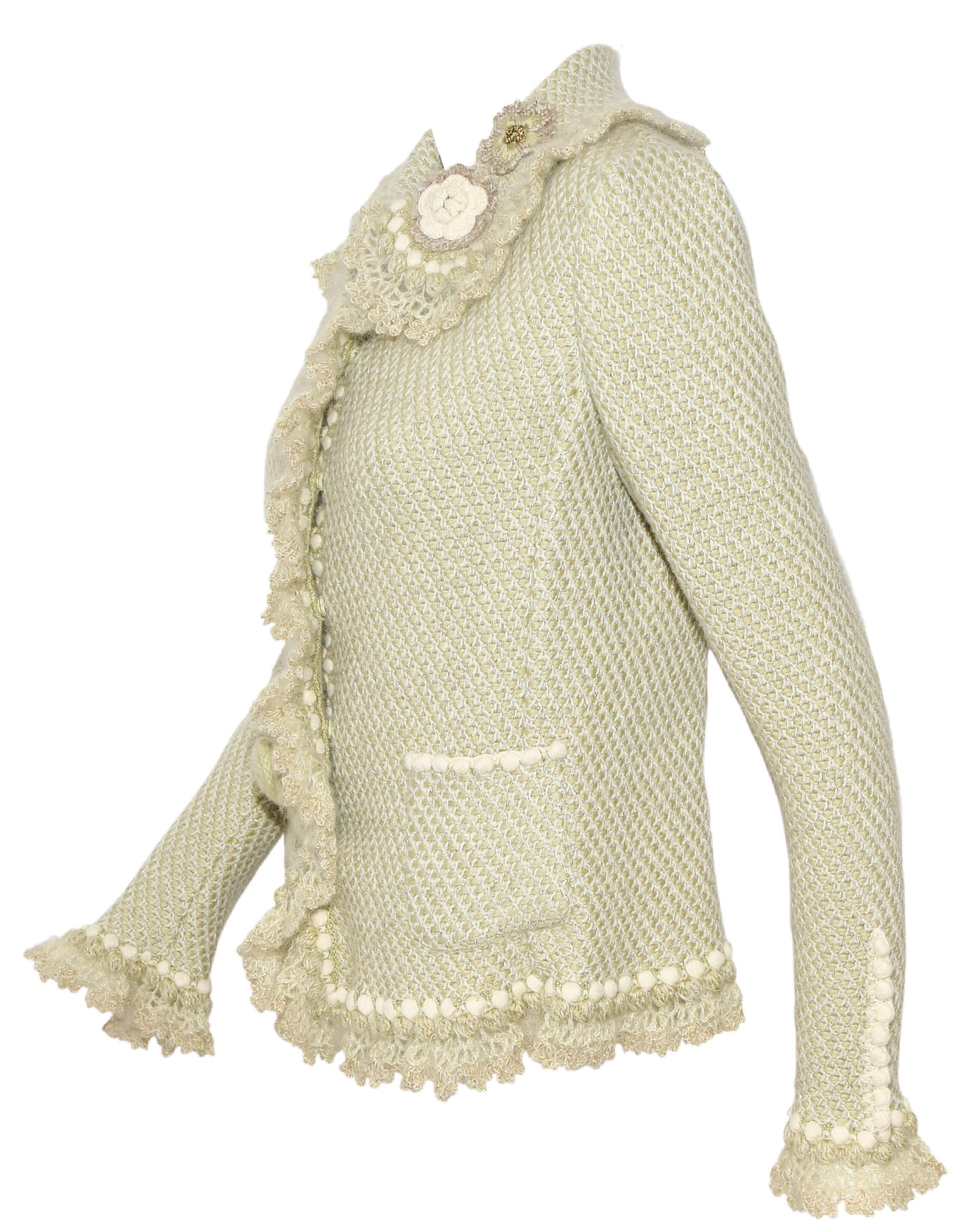 Oscar de la Renta pale green cashmere and wool sweater jacket includes crochet flowers on collar and one pocket.  Sweater jackets features round collar, two front patch pockets and ruffles on the front opening, cuffs and hem.  Excellent Condition! 