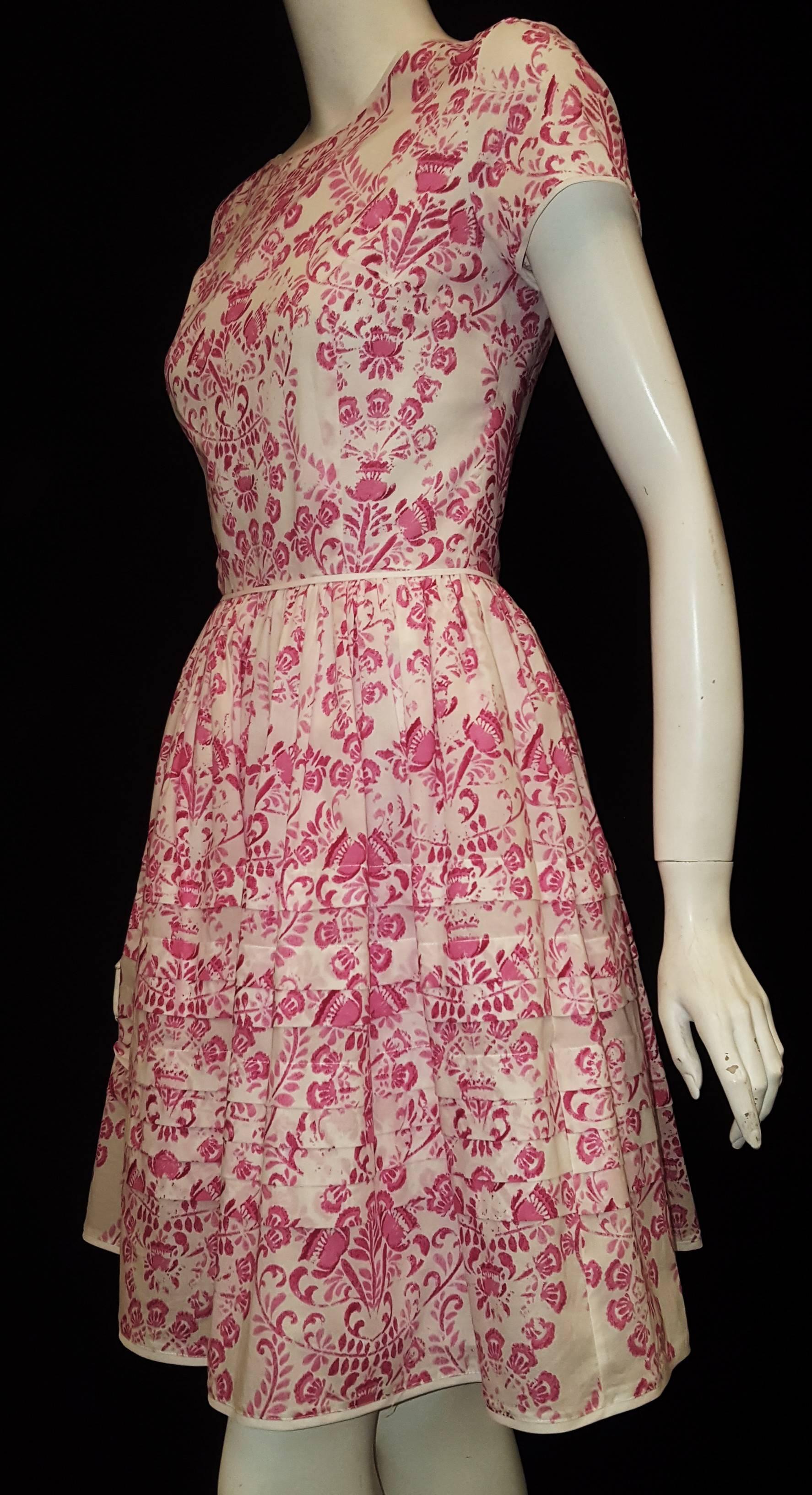 Oscar de la Renta cotton pink and white floral tile print dress with white trim around neckline, short sleeves, waist and hem is fresh and light for this upcoming summer season.   This Made in Portugal dress goes back to the Portuguese decorative