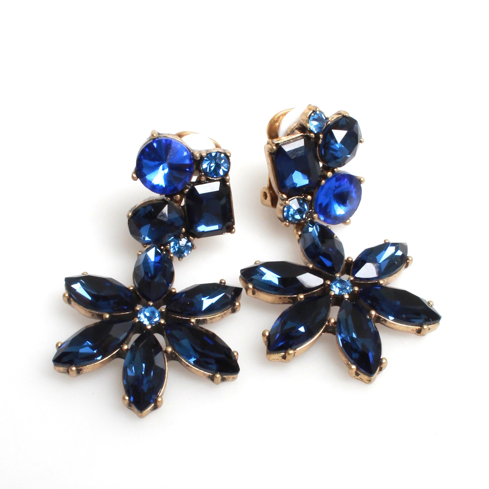 Oscar de la Renta blue floral drop clip on earrings with silver toned metal.
