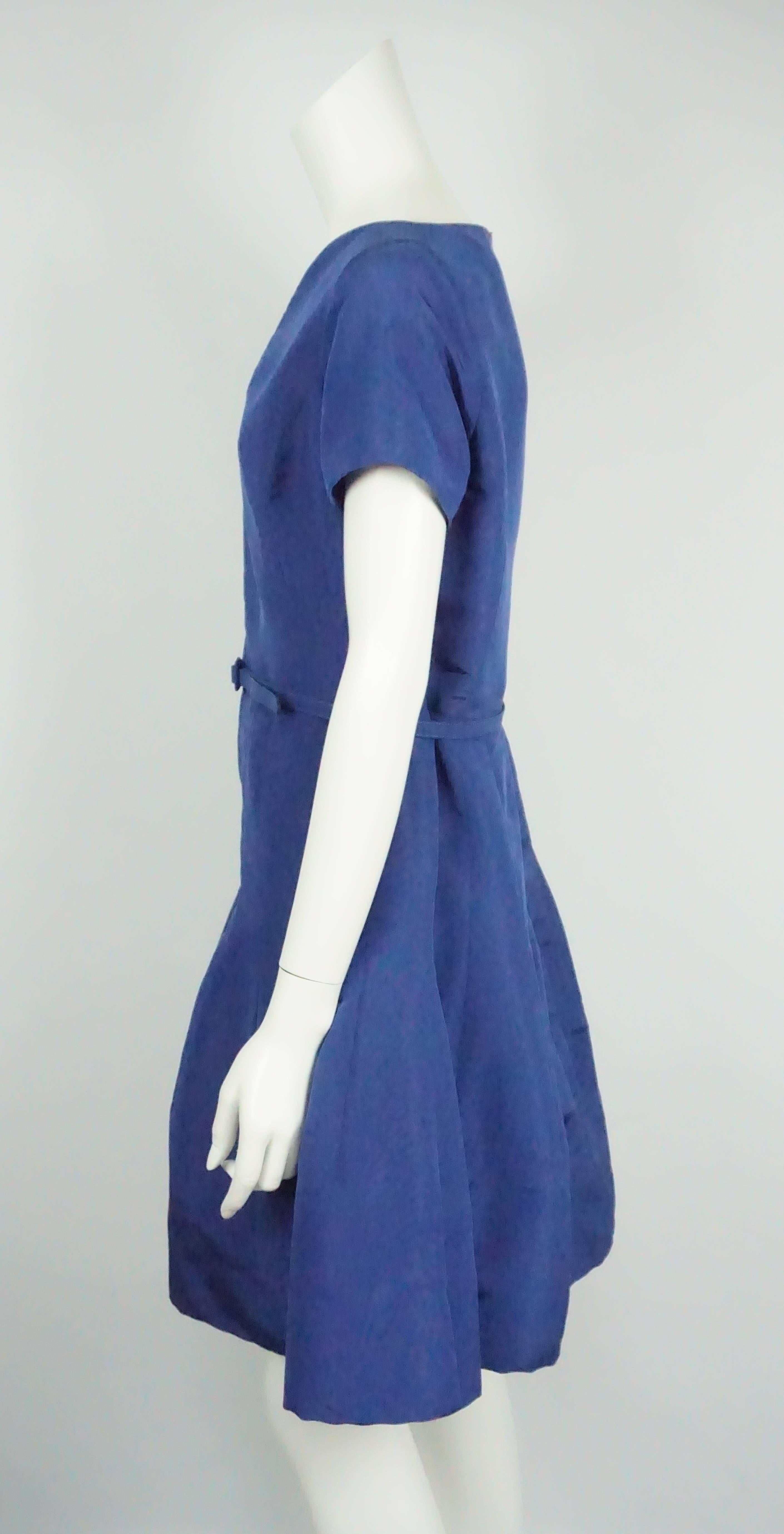 Oscar De La Renta Electric Blue Taffeta S/S Dress - 10  2015 collection. This elegant bubble skirt dress is made of silk. It has a short sleeve and a v-neck. The dress cinches in at the waist with a belt. There is a detail from the waist down that
