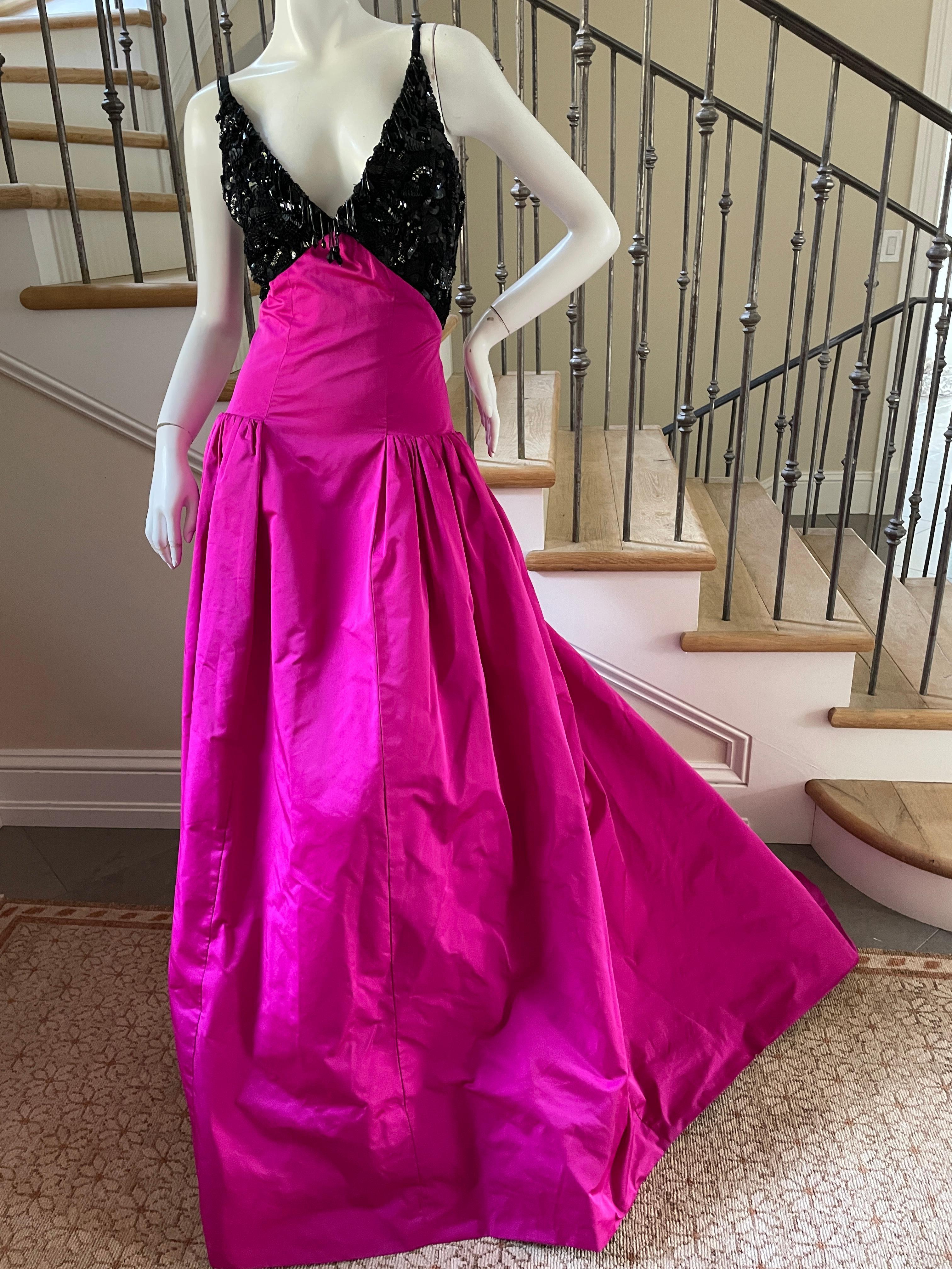 Oscar de la Renta Beaded Evening Dress with Fuschia Taffeta Ball Skirt and Train
Stunning. Please use the zoom feature to see all the remarkable details.
I believe this is a pre production sample, it has the sample tag underneath the Oscar de la